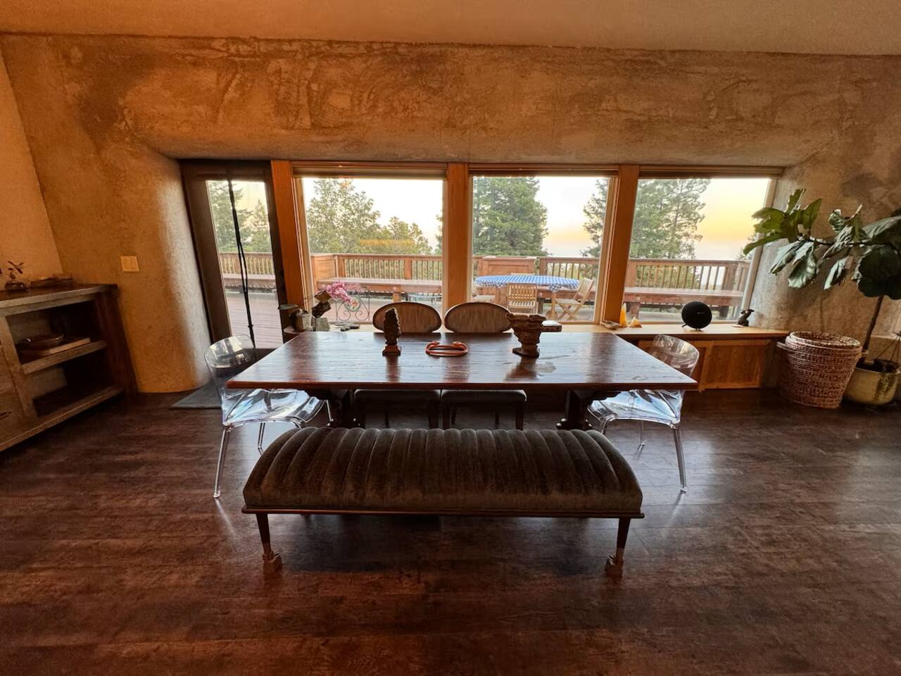 Savor group meals at a dining table framed by stunning forest views.