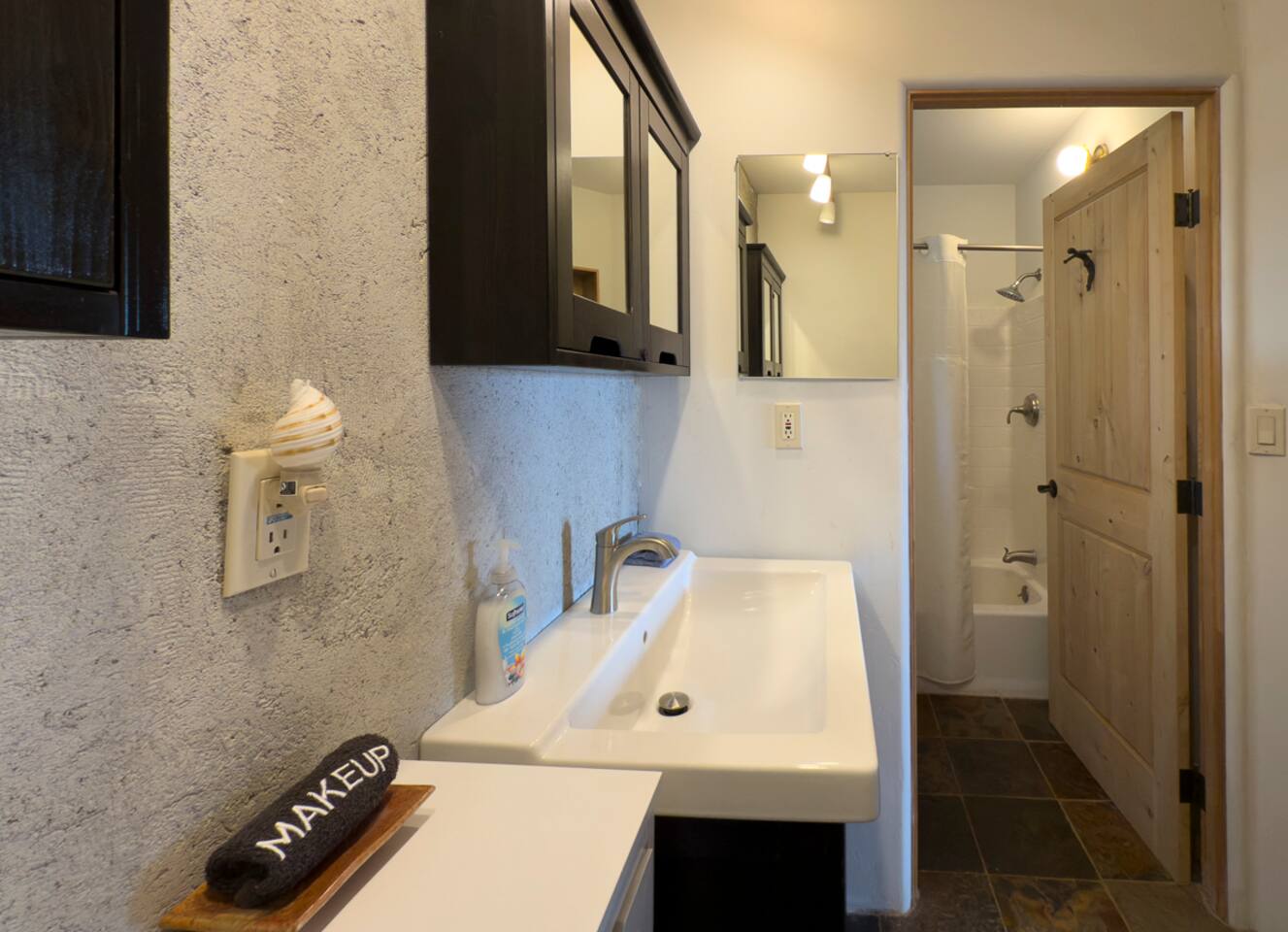 Modern bathroom with sleek finishes and natural stone tile.