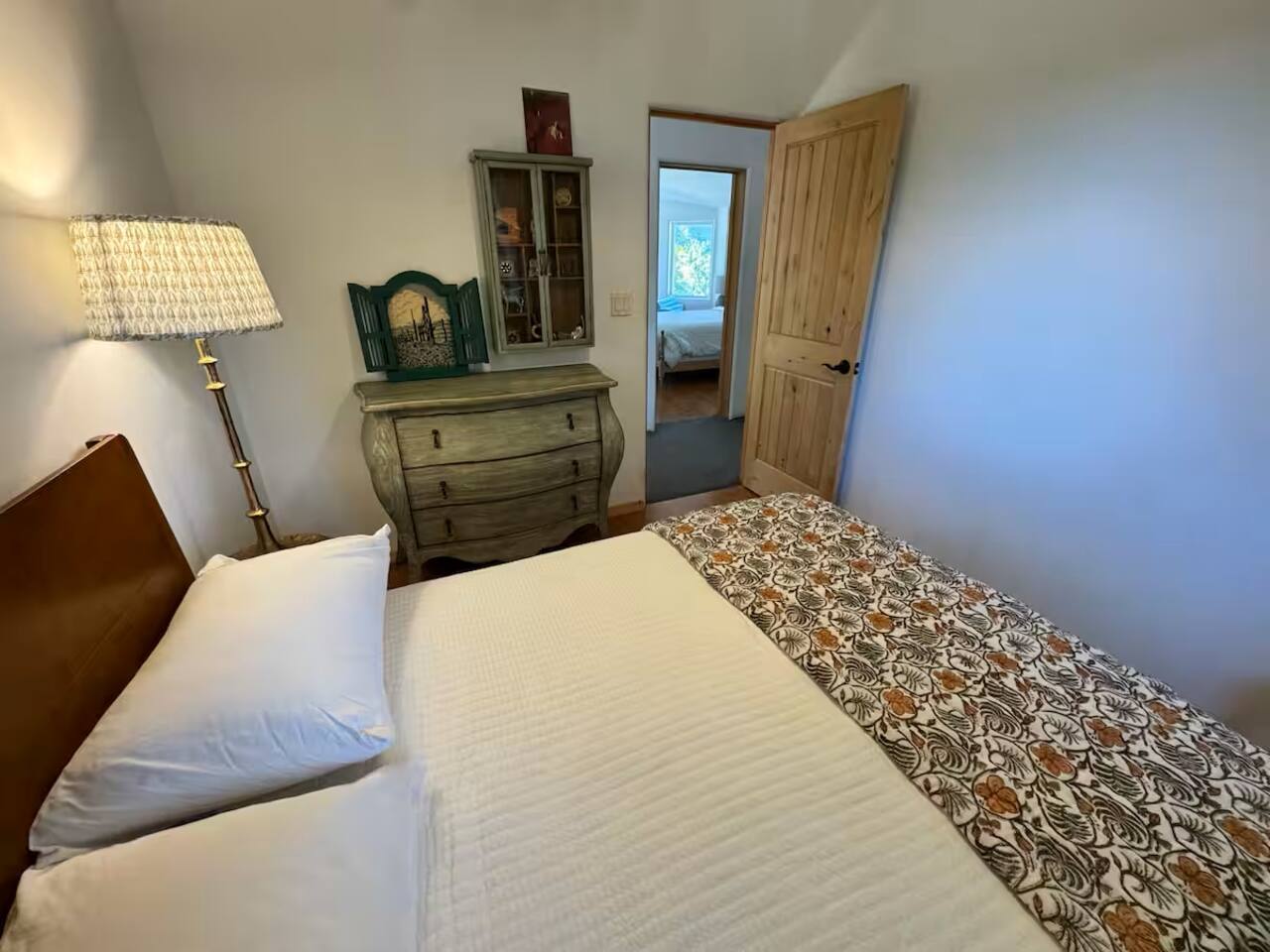 Spacious bedroom with dresser for your convenience.