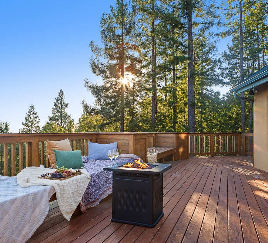 Spacious forest-view deck with fire pit and cozy lounge seating