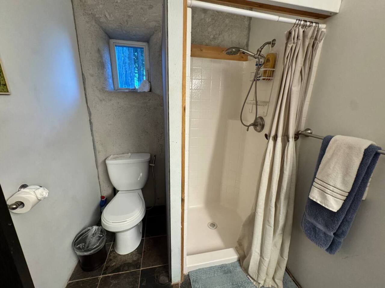 Walk-in shower with spa-like stone flooring.