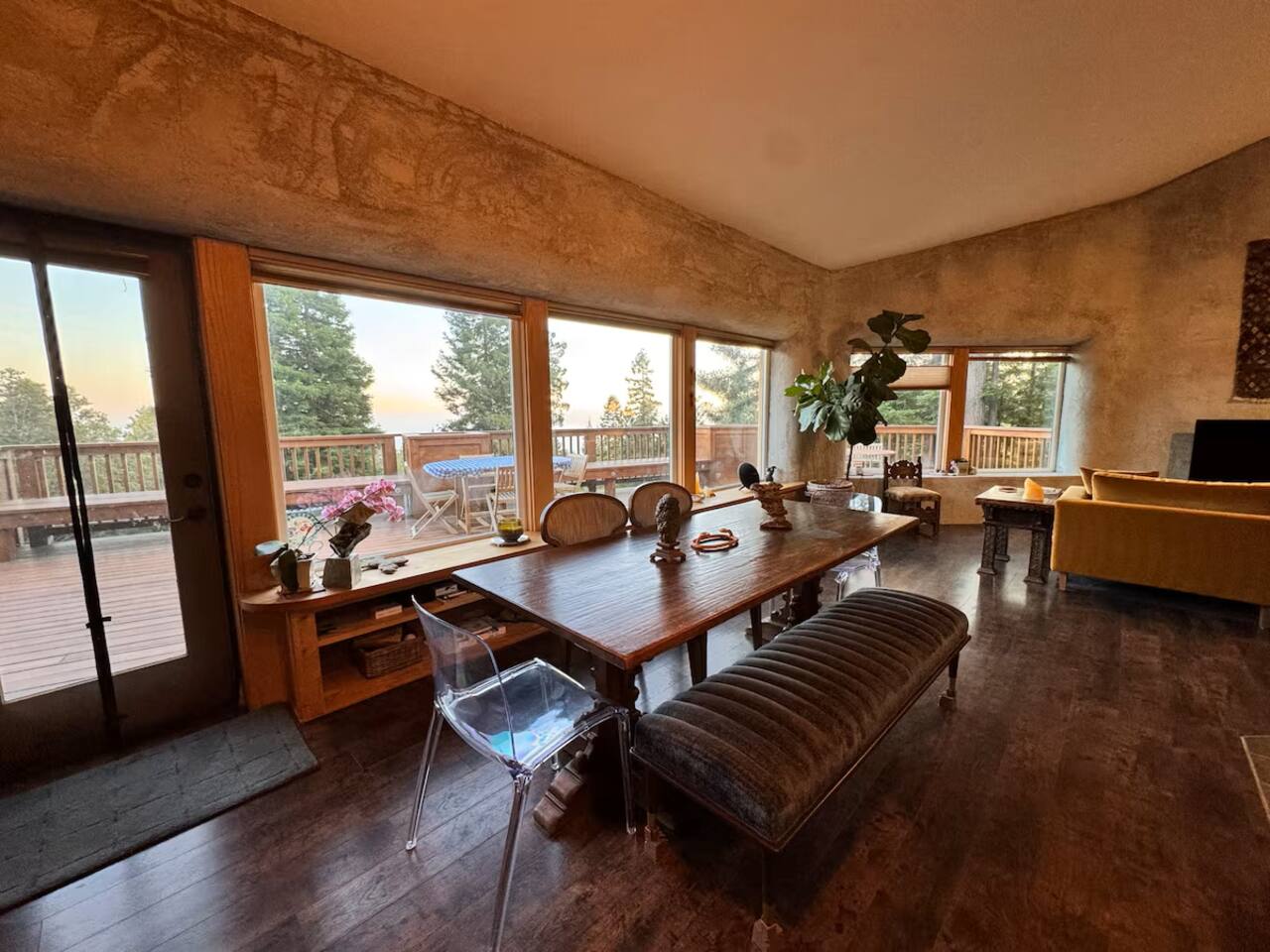 Spacious dining area surrounded by windows and natural light.