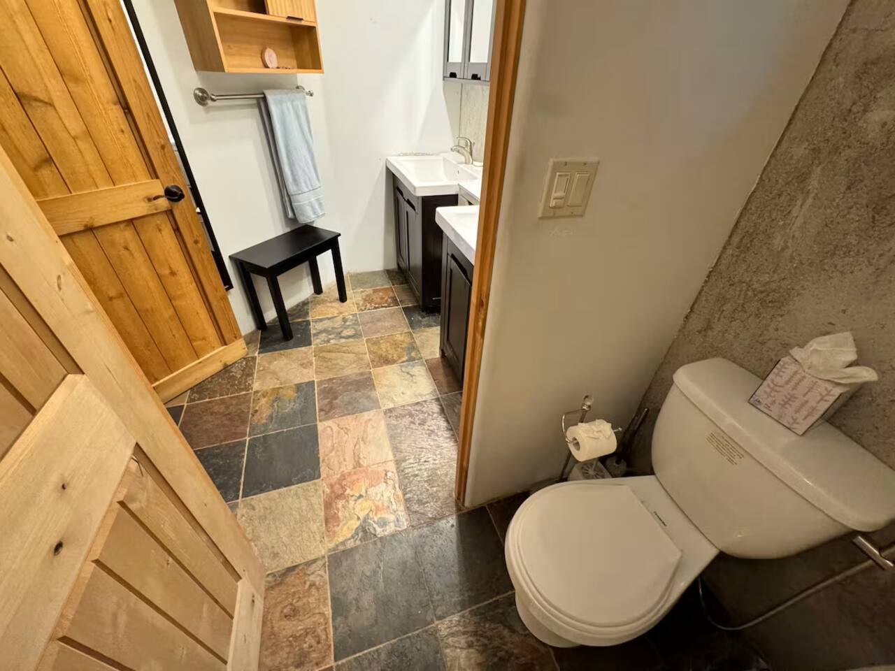 Modern bathroom with sleek finishes and natural stone tile.