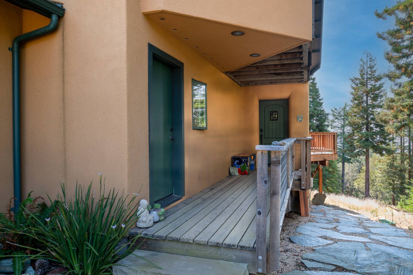 Main entrance surrounded by redwoods — your own forest escape.