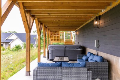 Kick back on the covered lower deck in the comfy outdoor sectional and chairs. This shaded nook is ideal for morning coffee or evening conversations after adventures on the New River, mountain hikes, or exploring Boone and Blowing Rock.