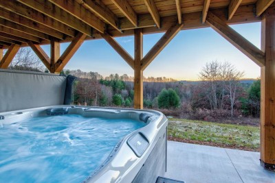 Unwind in the private hot tub under the covered deck while taking in sweeping mountain and pink-sky sunsets after a day of exploring Boone and Blowing Rock.