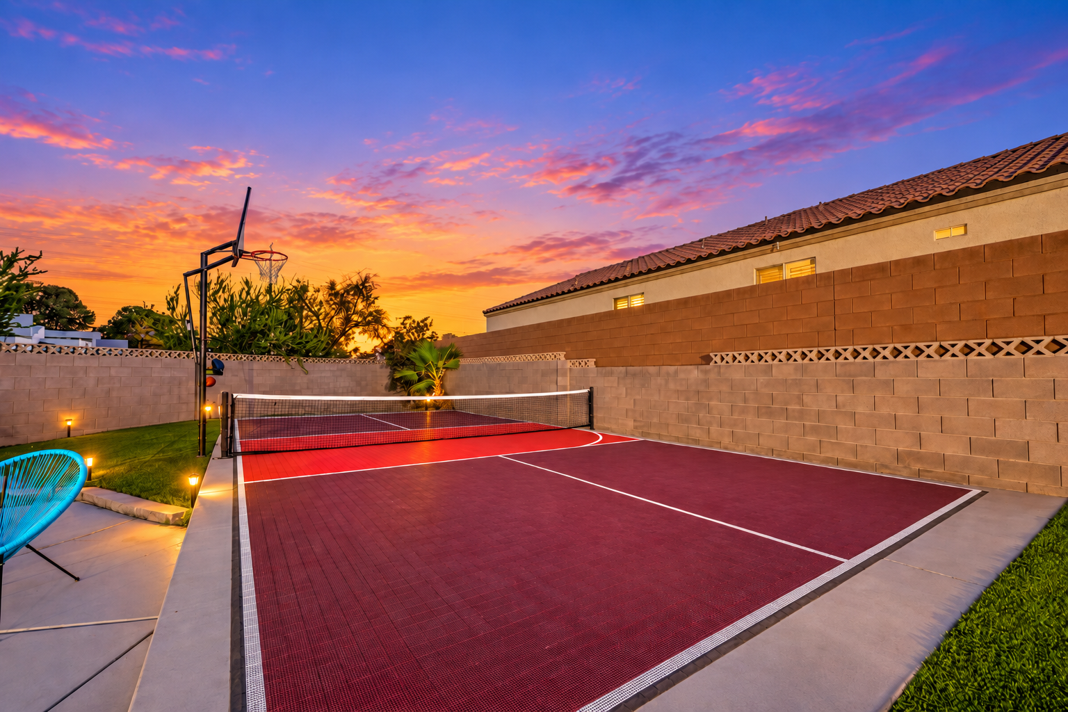 Private sunset sport court with pickleball net and basketball hoop