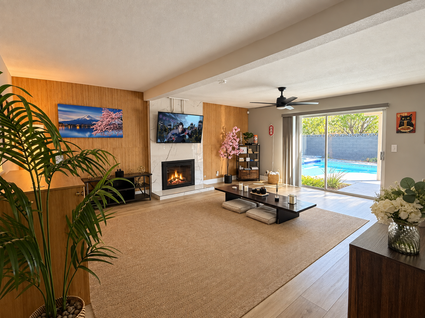 Spacious living room with fireplace, TV, and private pool access