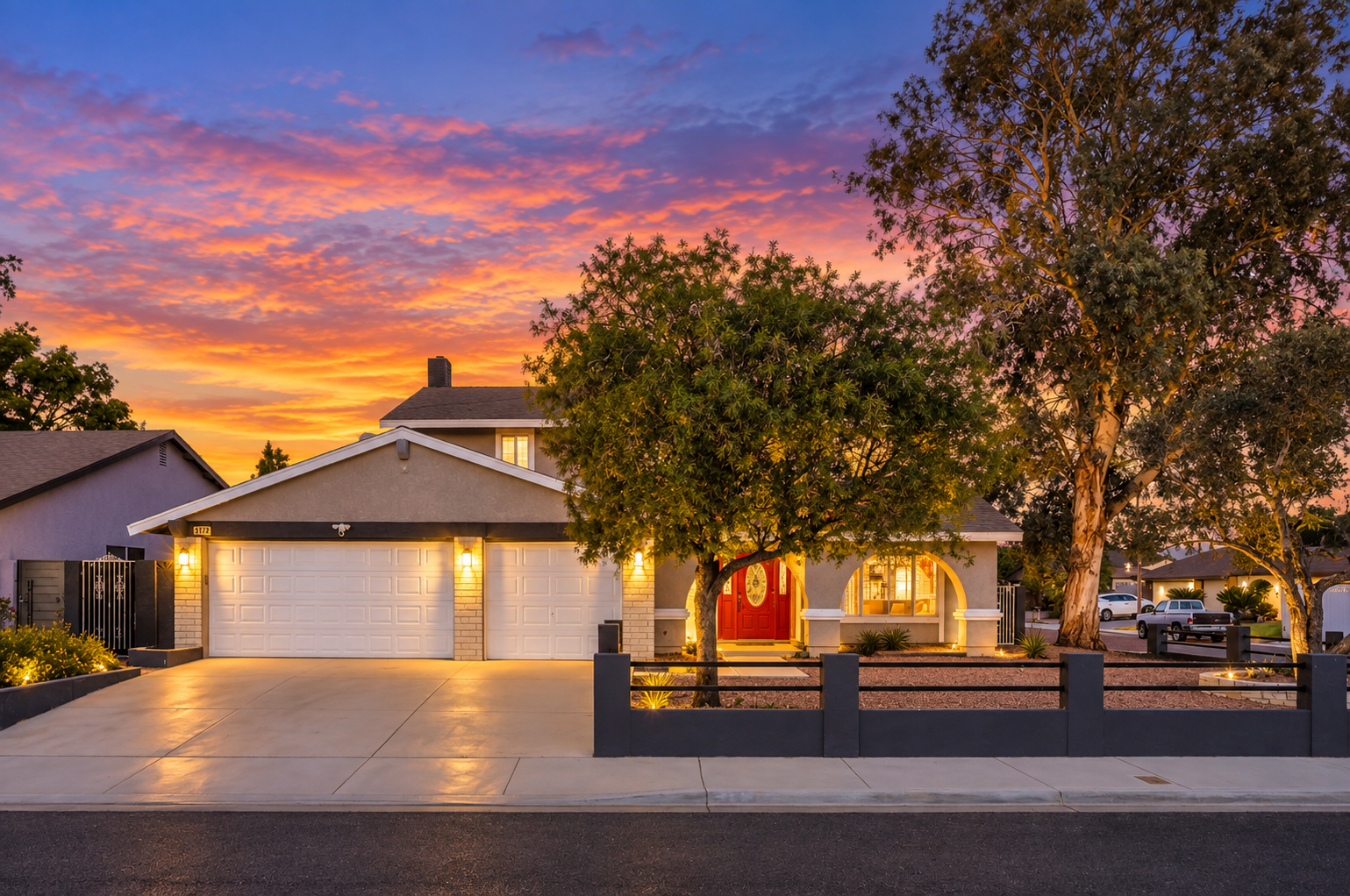 Inviting sunset curb appeal with warm lighting and spacious parking