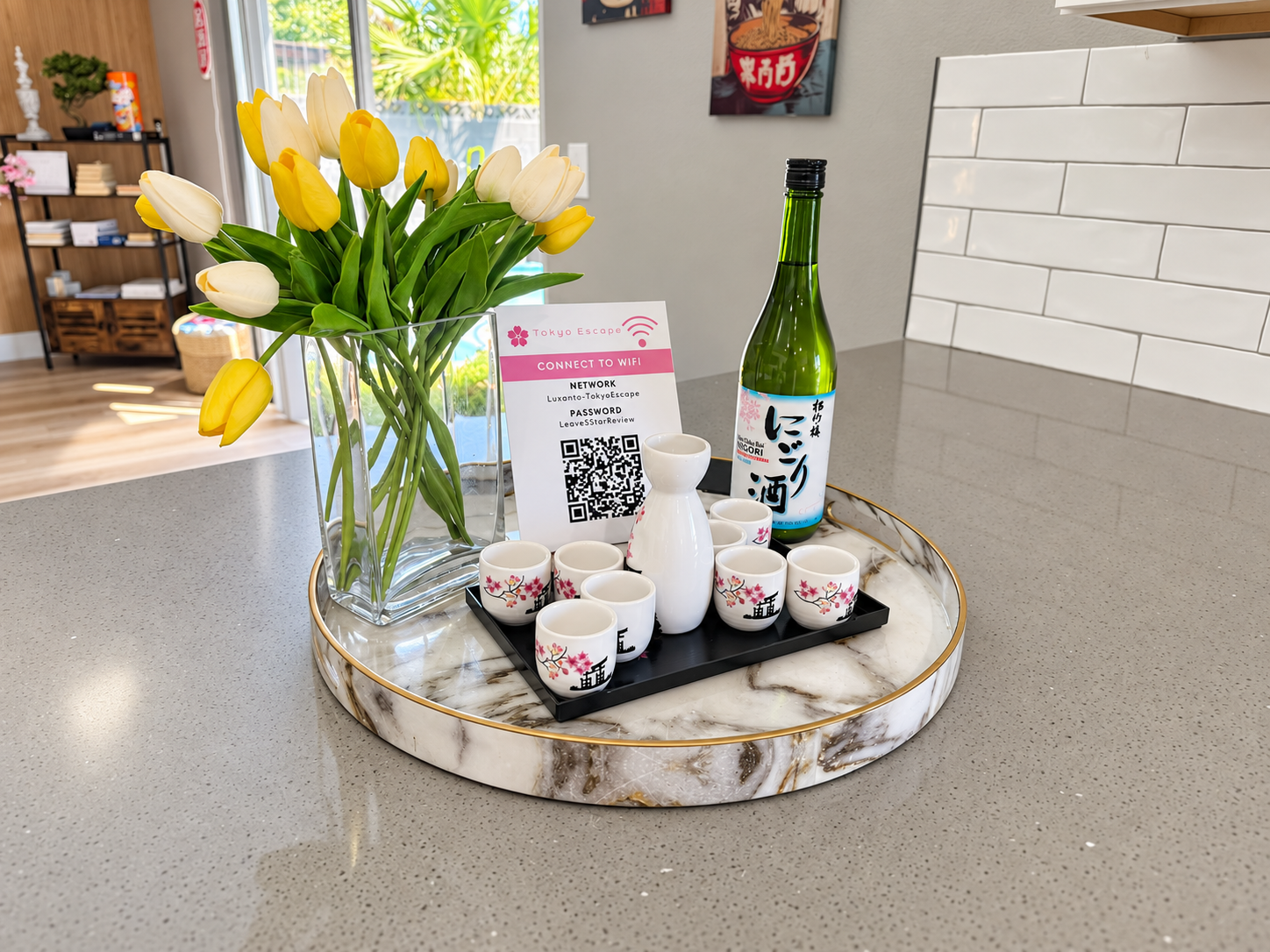 Thoughtful welcome setup with sake, Wi-Fi QR code, and fresh tulips