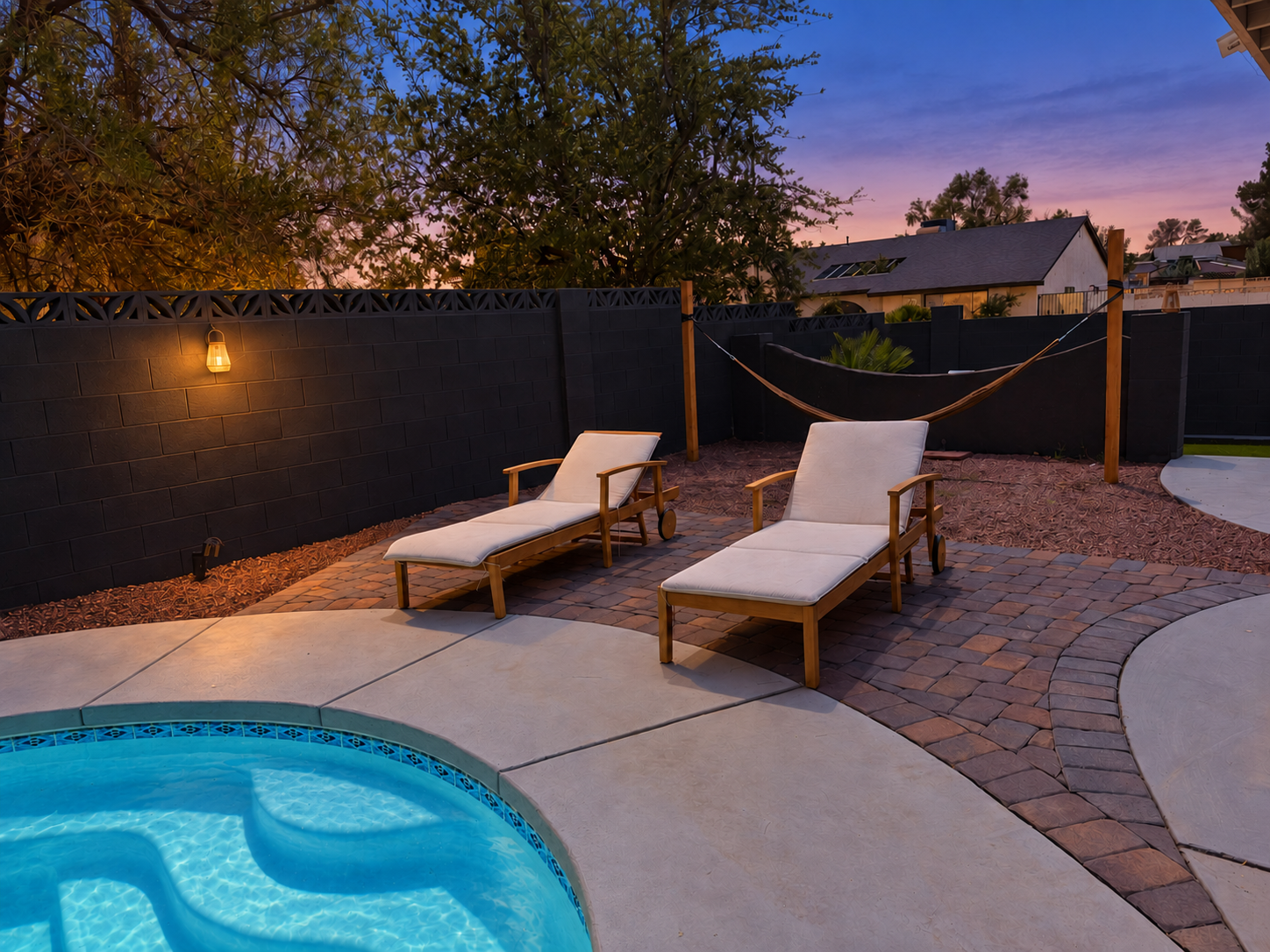 Private poolside retreat with loungers and hammock at sunset