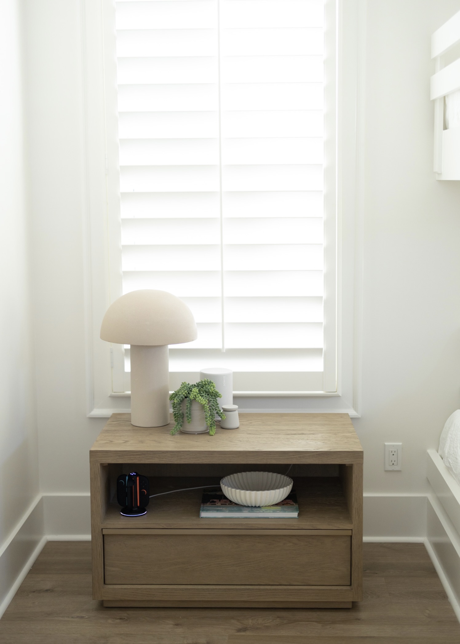 A quiet corner with a sculptural lamp and a plant