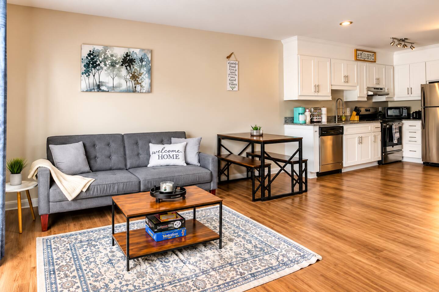 Bright, open-concept living space with a cozy lounge, dining area, and fully equipped kitchen