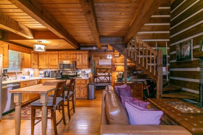 Experience true open-concept living—prepare meals in the fully equipped kitchen while family chats at the bar table, then relax on the sectional sofa just steps away.