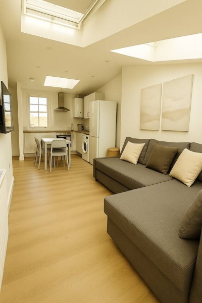 Compact open-plan with skylights, cozy sofa, and modern kitchen.