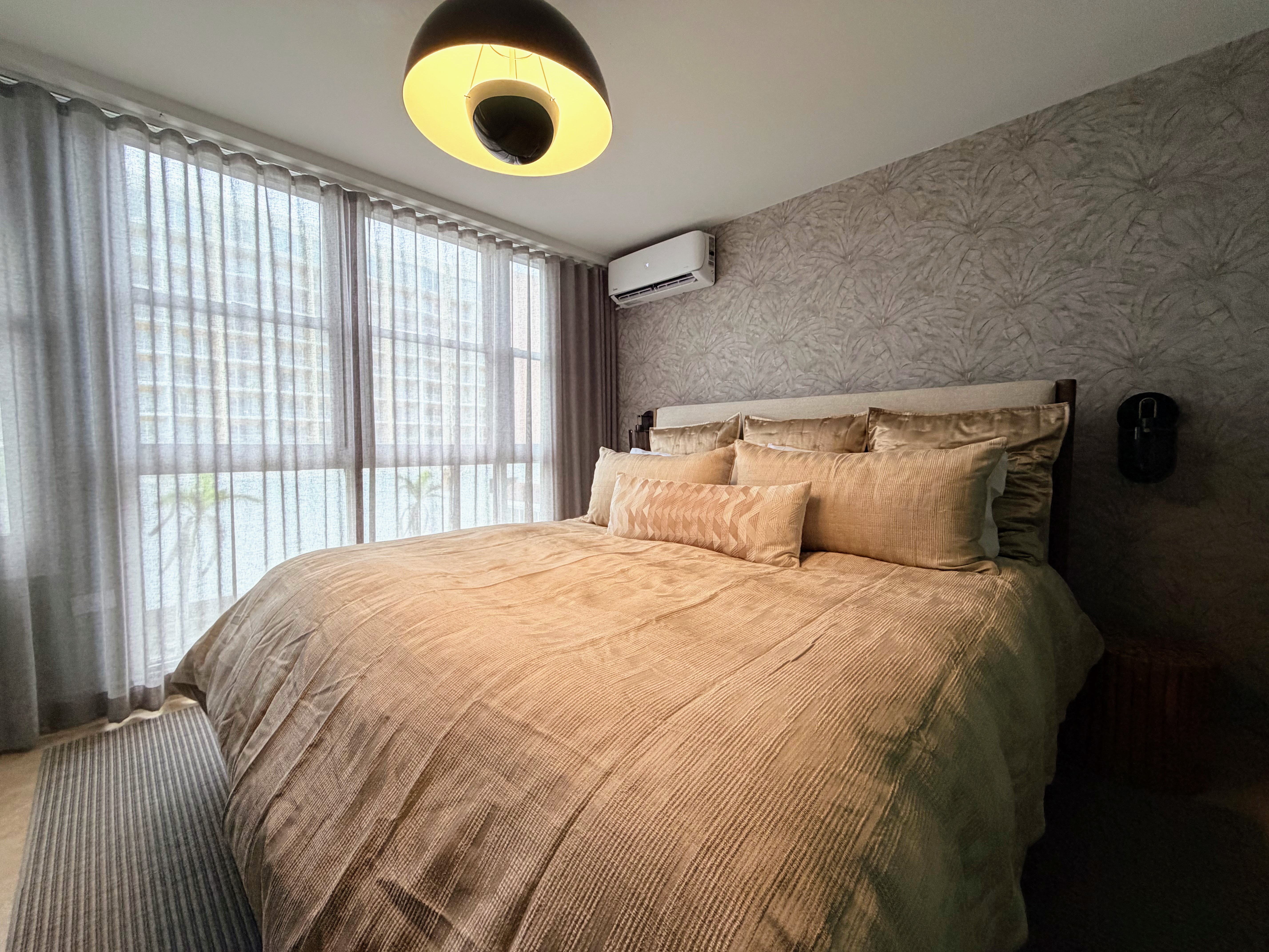Bright, cozy bedroom with plush king bed and soft natural light