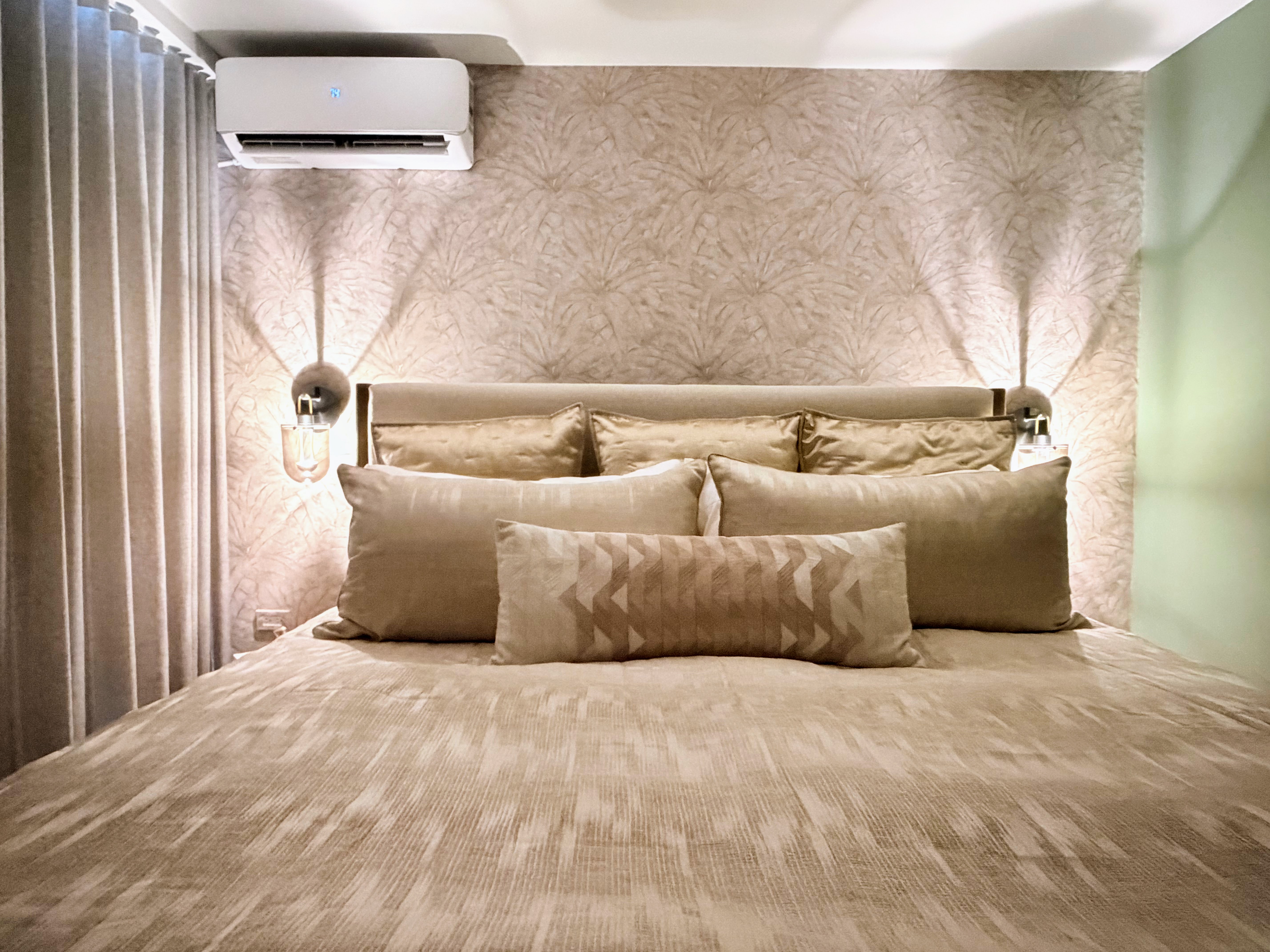 Cozy designer bedroom with plush linens, soft lighting, and AC