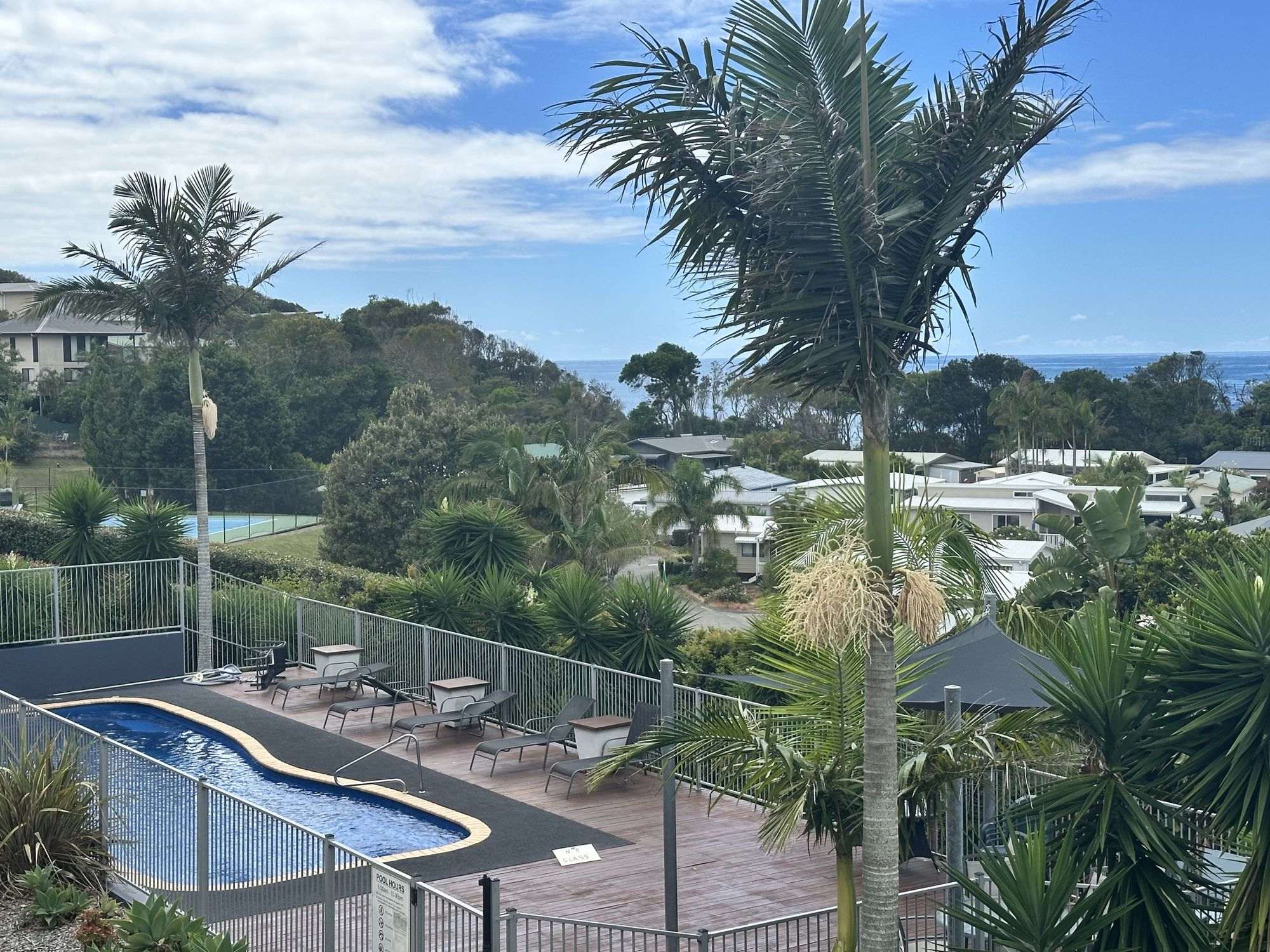 Tropical pool deck with loungers and peaceful ocean-view surrounds