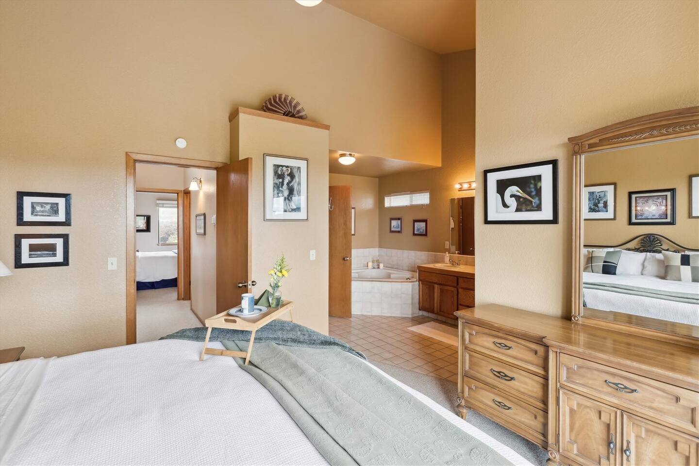 Master bath with ensuite bathroom including a jetted tub and dual sinks
