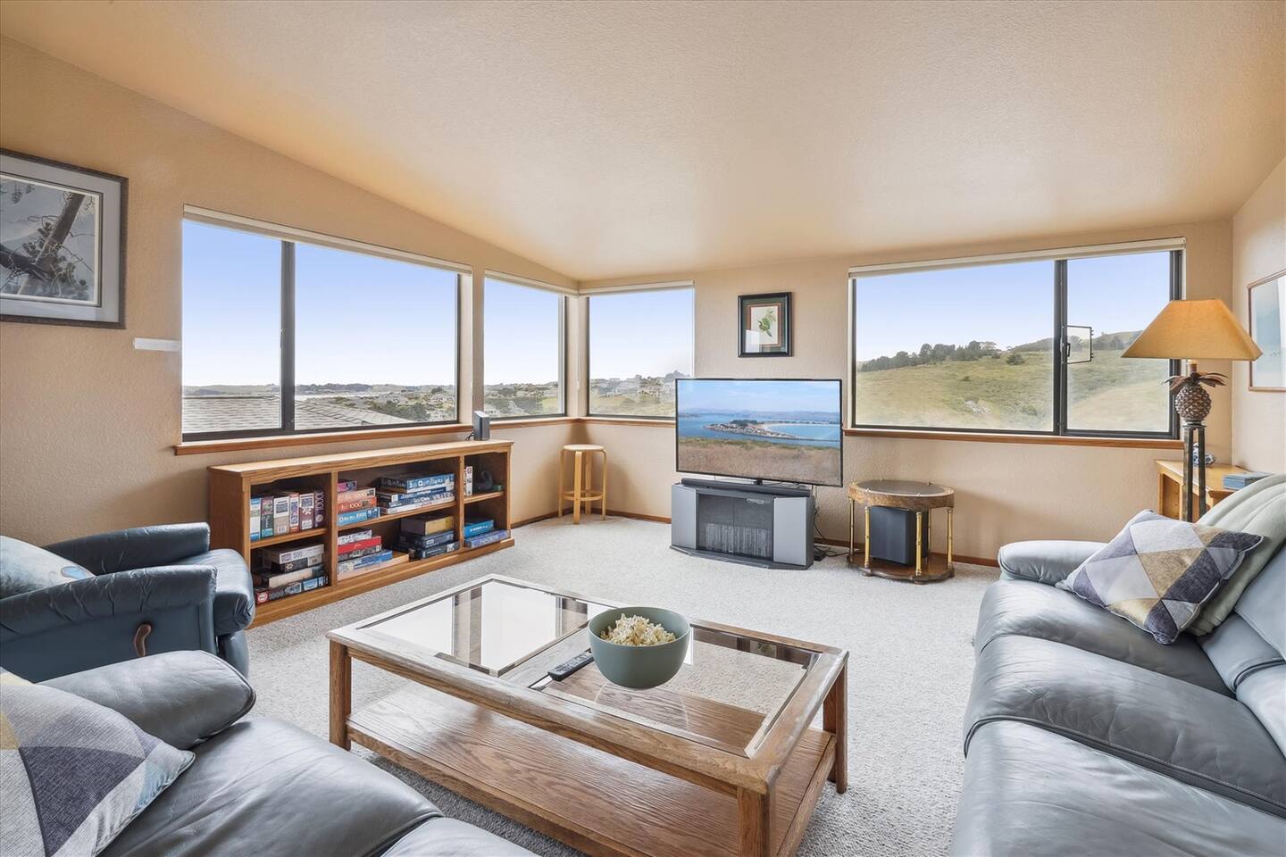 Home theater setup with a 55" TV, Sound Bar, Blu-Ray player, and comfy leather sofas.