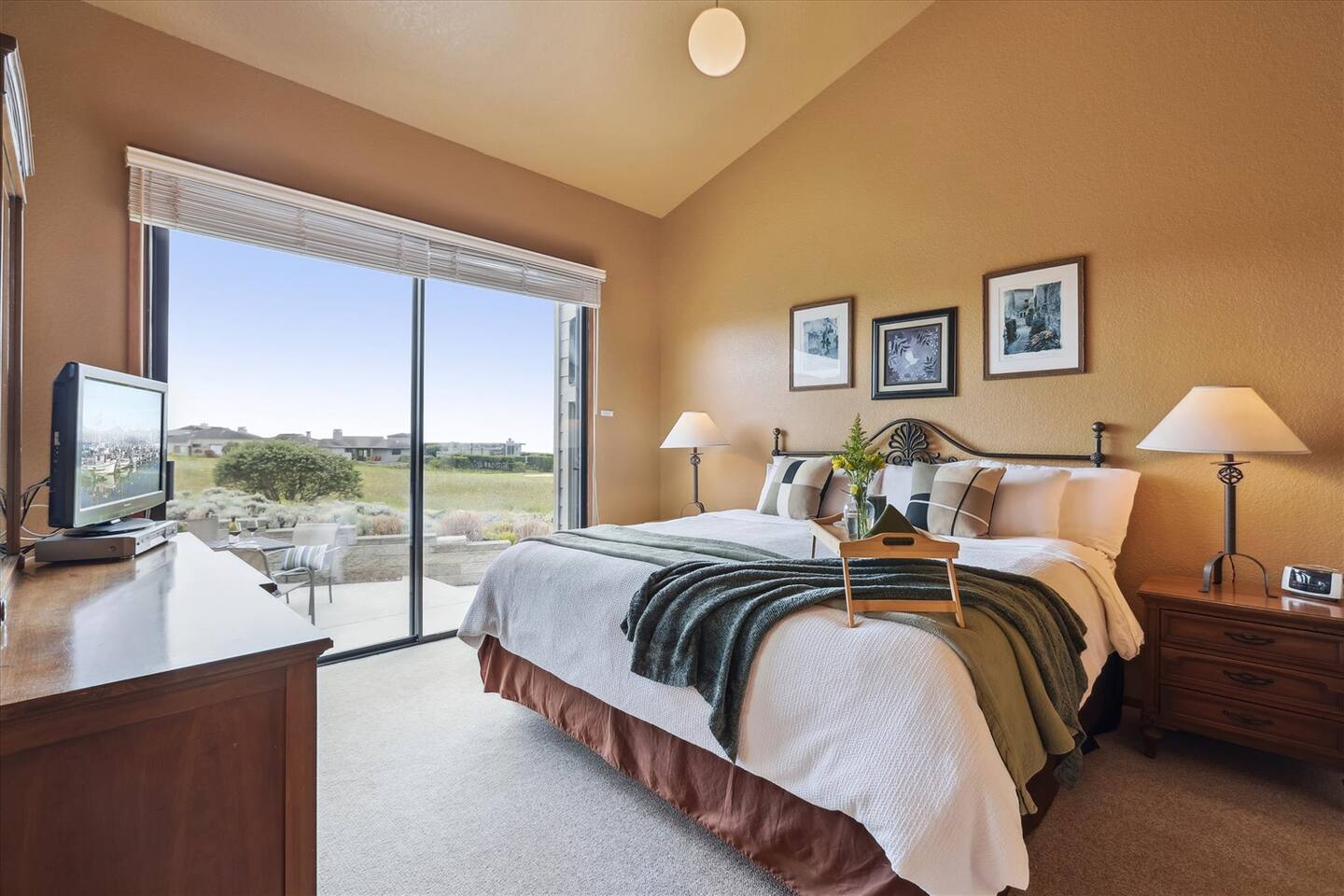 Master bedroom with a King Stearns & Foster Ann Marie Luxury Firm mattress. The sliding door gives you direct access to the spacious patio and ocean views beyond.