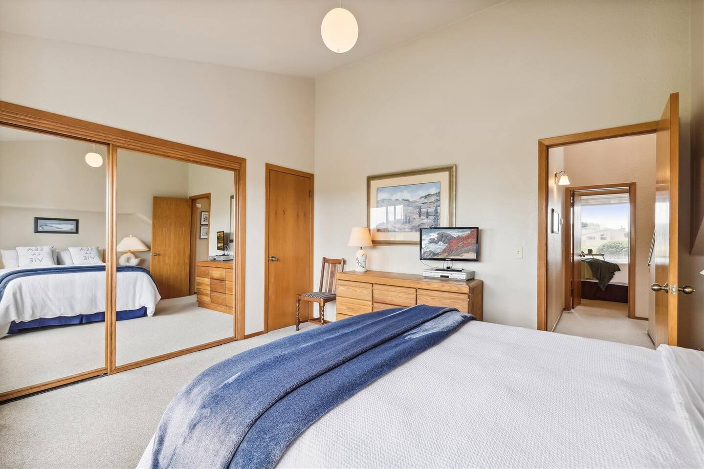 The downstairs bedroom has a large closet with mirrored doors and cable TV with a DVD player.