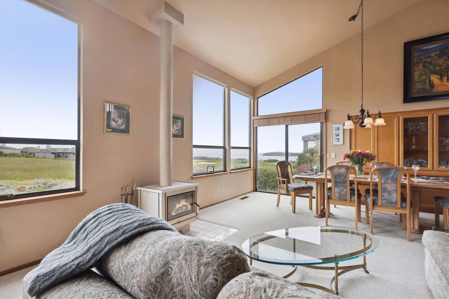 The wood-burning stove is flanked by two large windows, allowing you to warm yourself as you relax and take in the view.