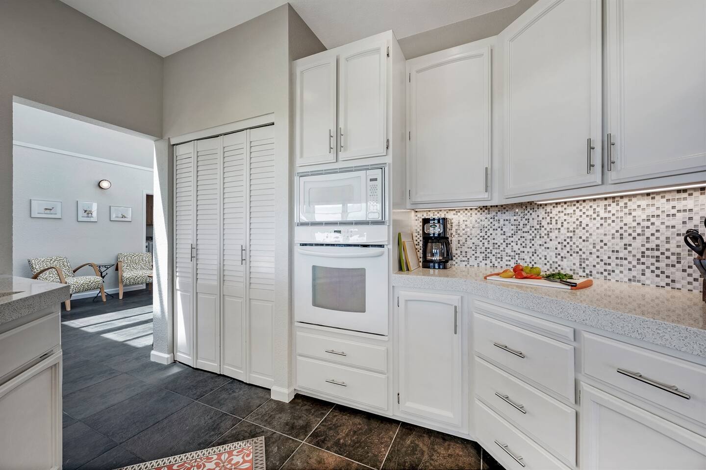 Quality cabinets stocked with a selection of dishes and glassware, plus a spacious pantry.