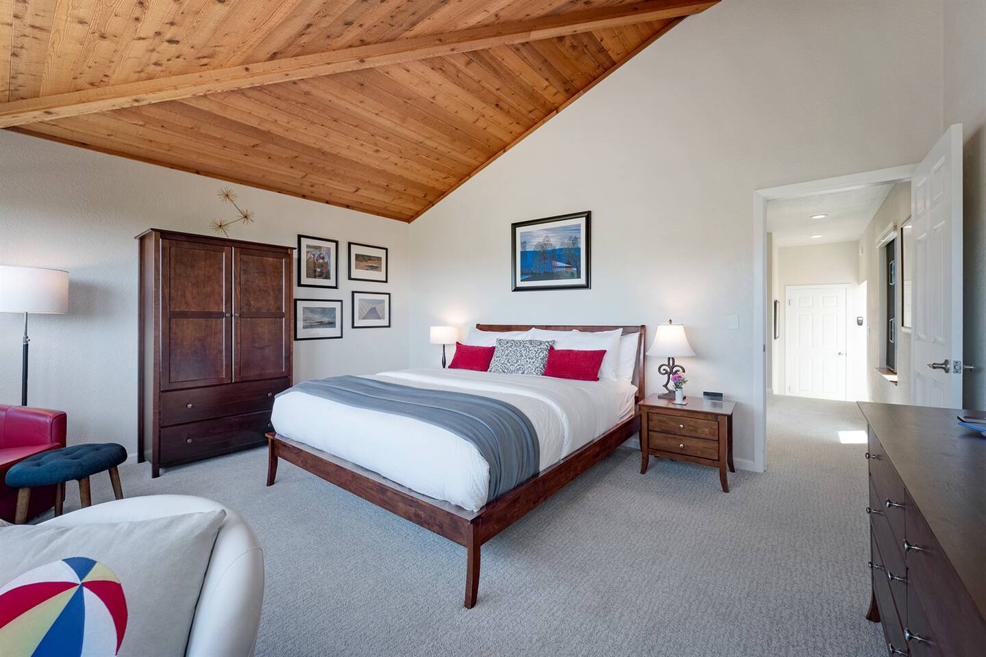 Large bedroom in the front of the home has a King bed, vaulted wood ceilings,and plenty of storage.