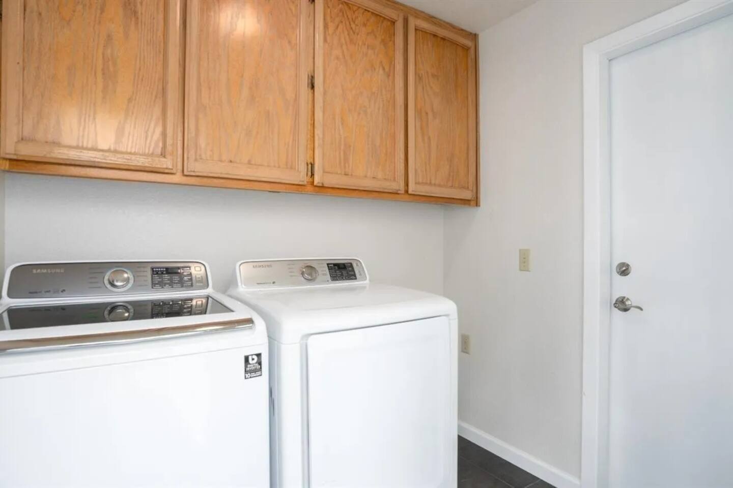 Full size washer and dryer with provided detergent and laundry supplies.