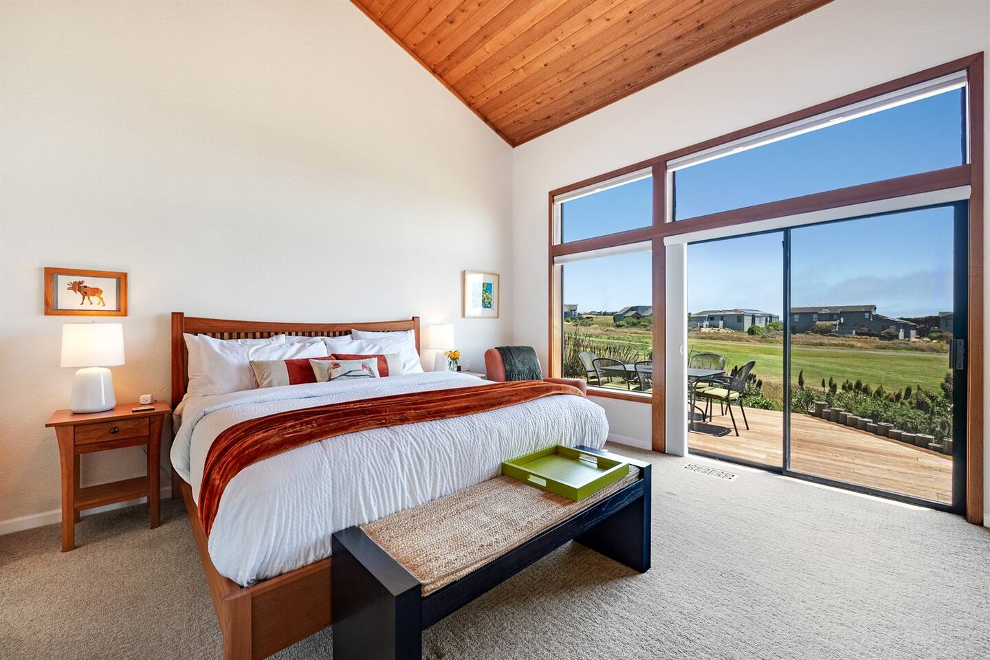 You can access the back deck from the primary bedroom, with views of the golf course and ocean.