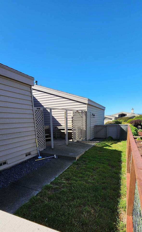 Large private fenced-in dog run in the side yard, accessed from the center courtyard of the home.