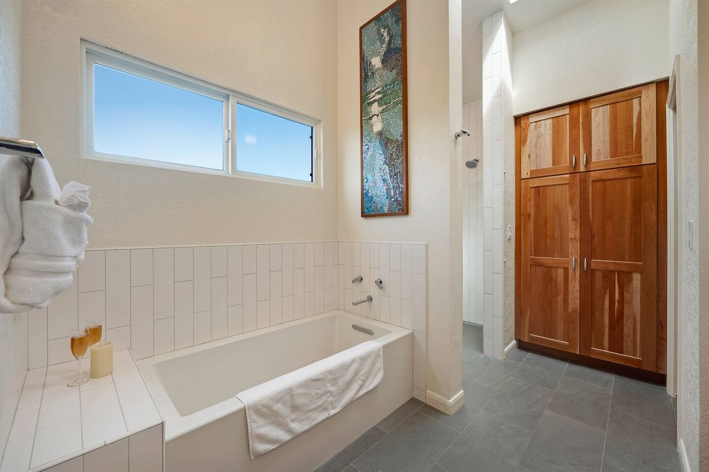 Primary bathroom with a large soaking tub and a walk-in shower. Lots of natural light from the skylight above.