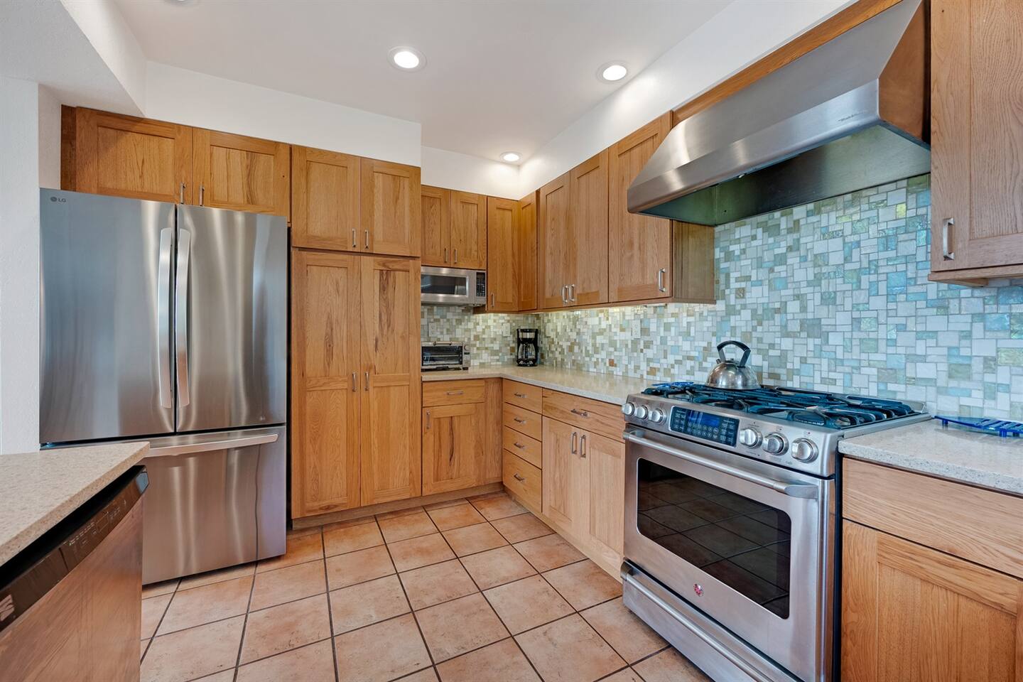 Stainless steel appliances. LG refrigerator has an icemaker. Gas stovetop and electric oven.