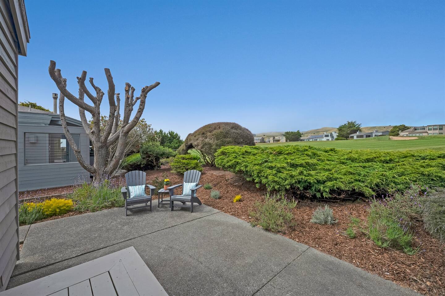 Back deck with a view of the golf course, accessible via a sliding glass door from the primary bedroom.