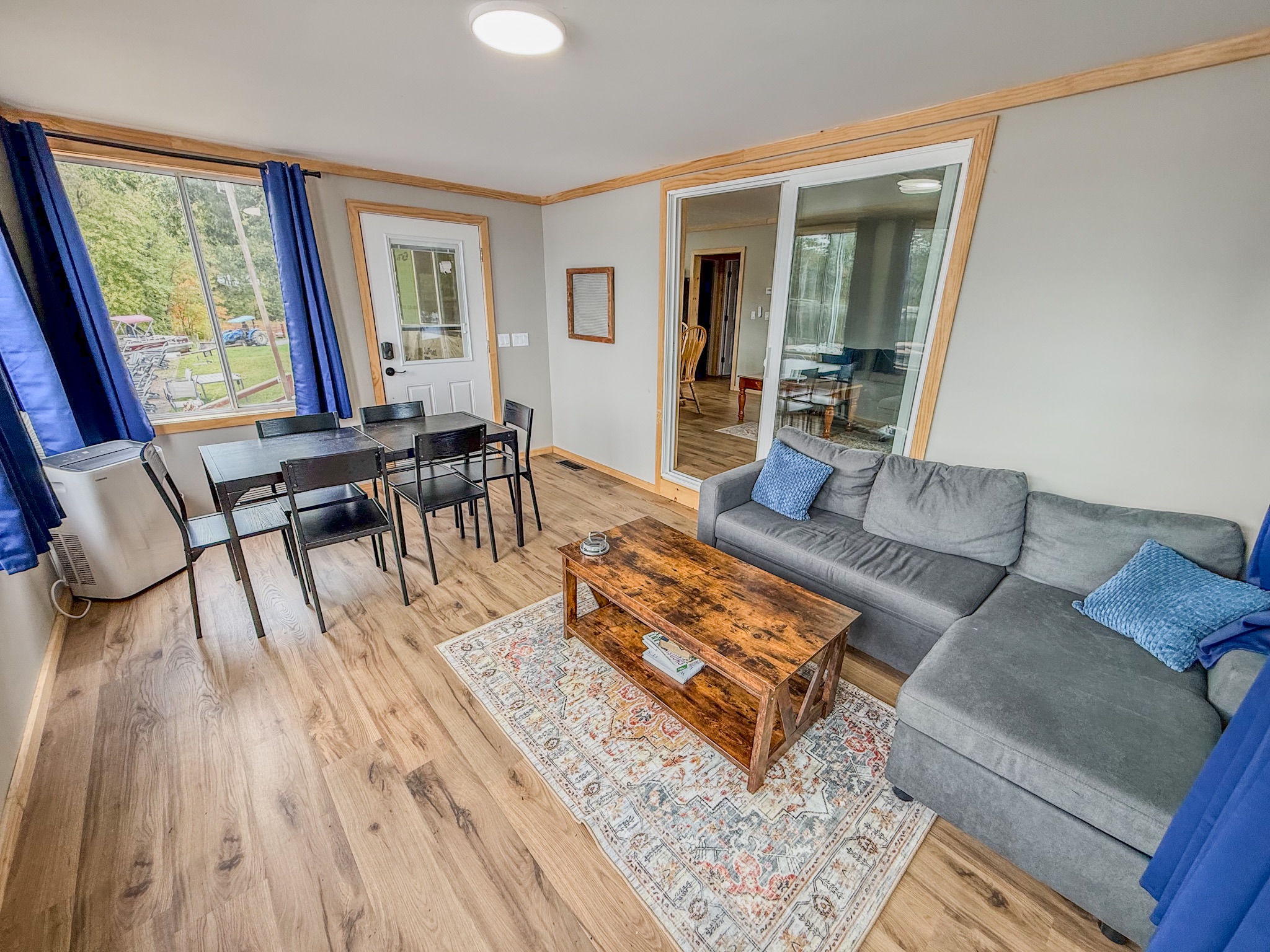 Bright open living area with sectional seating and dining for four