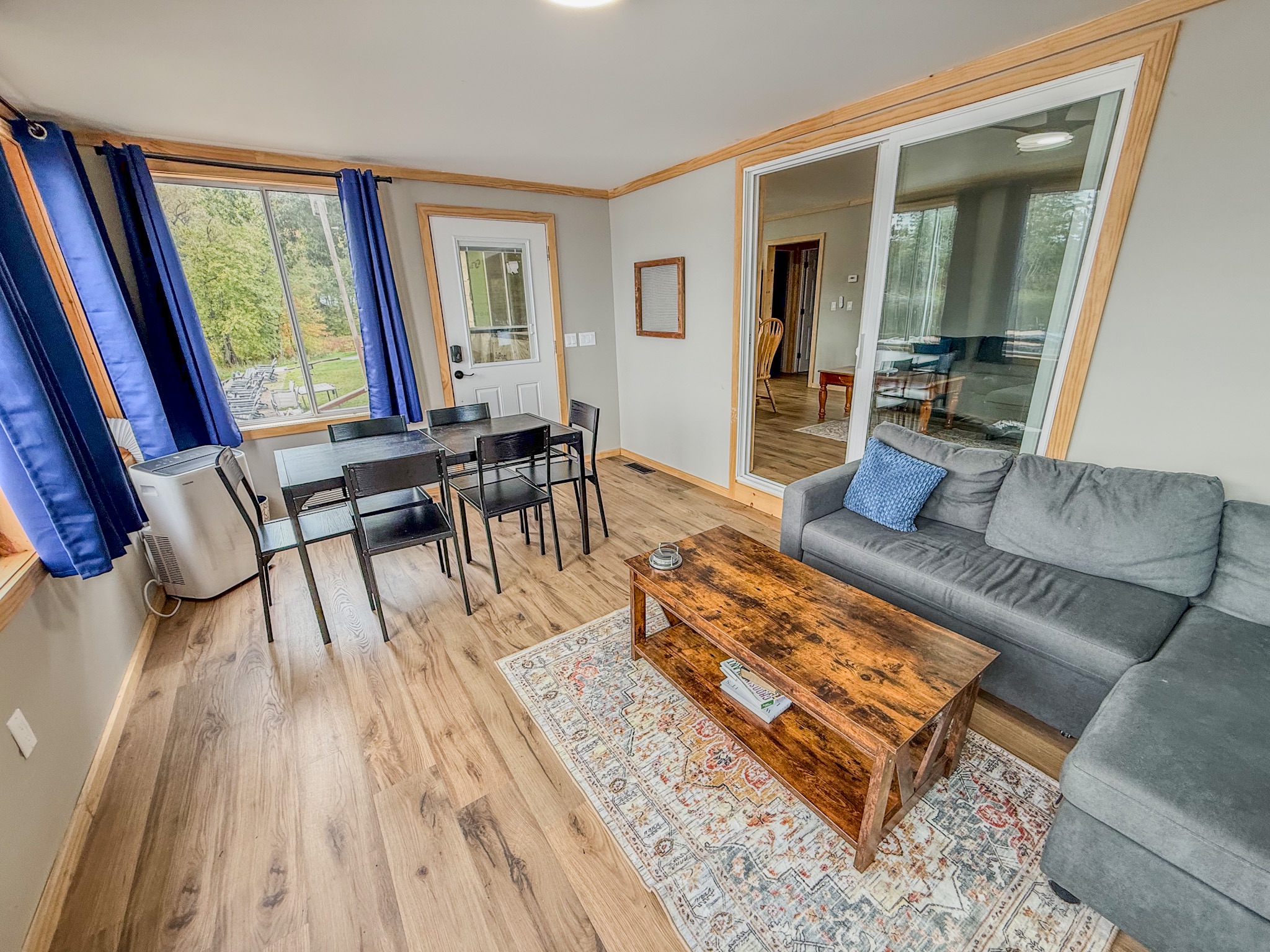 Bright living area with sectional, dining for 4, and scenic views