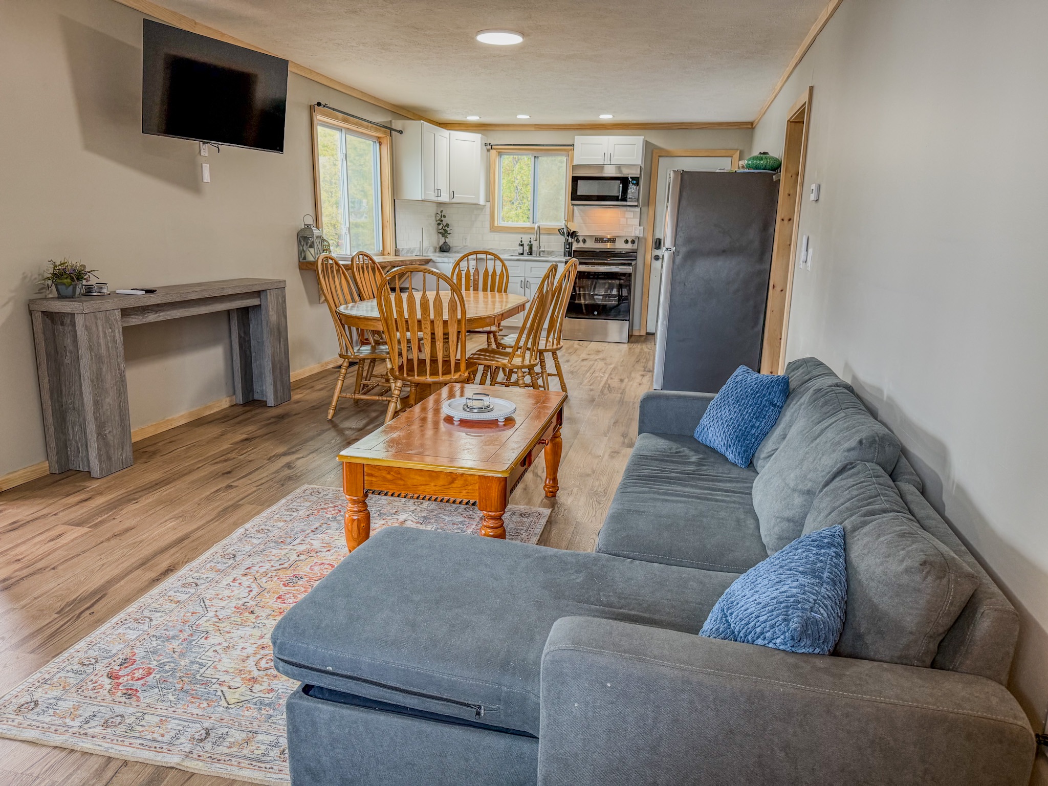 Bright open living space with sectional, dining for 6, and full kitchen