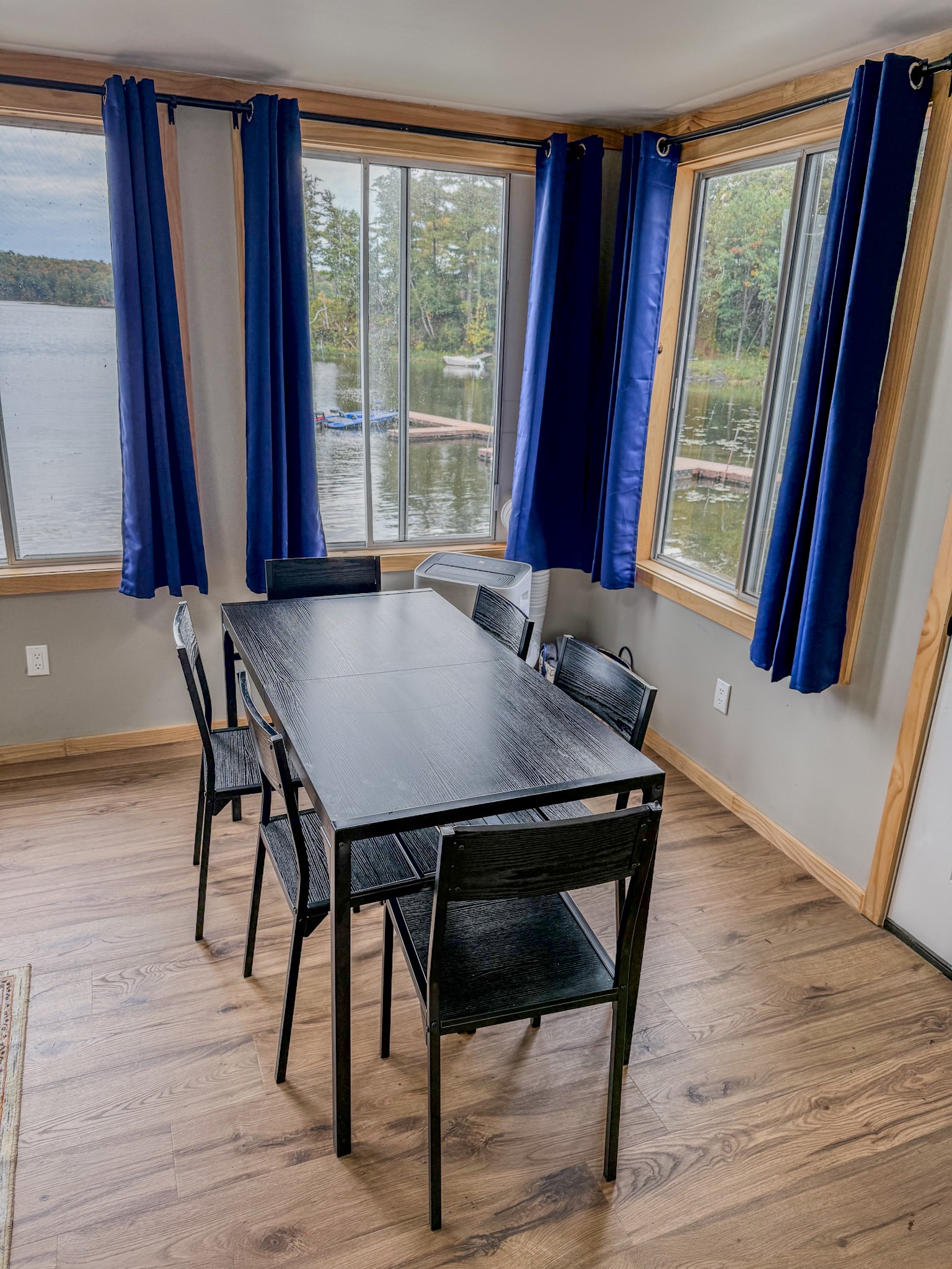 Bright waterfront dining area with lake views and seating for six