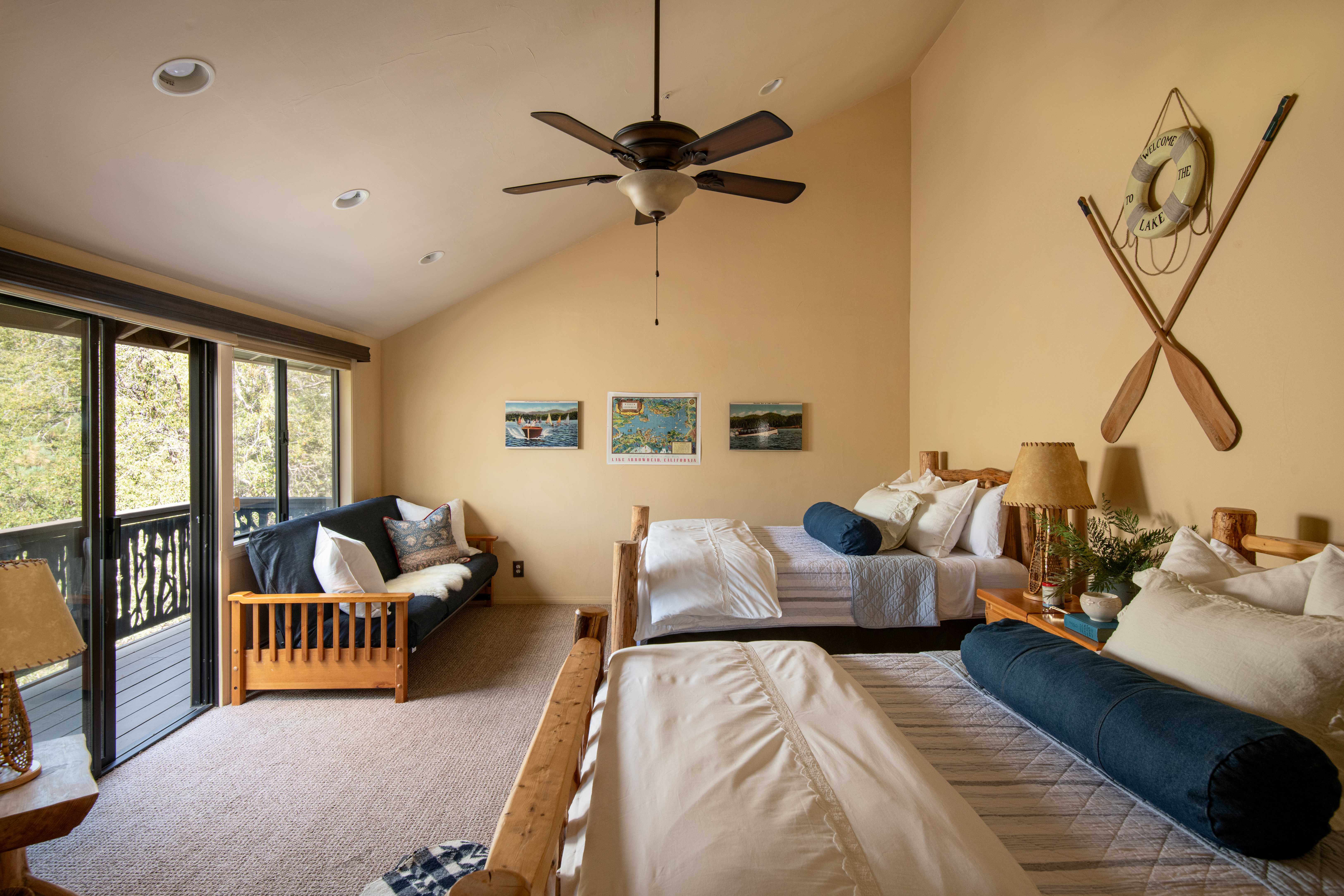 Spacious family bedroom with balcony access and peaceful wooded views