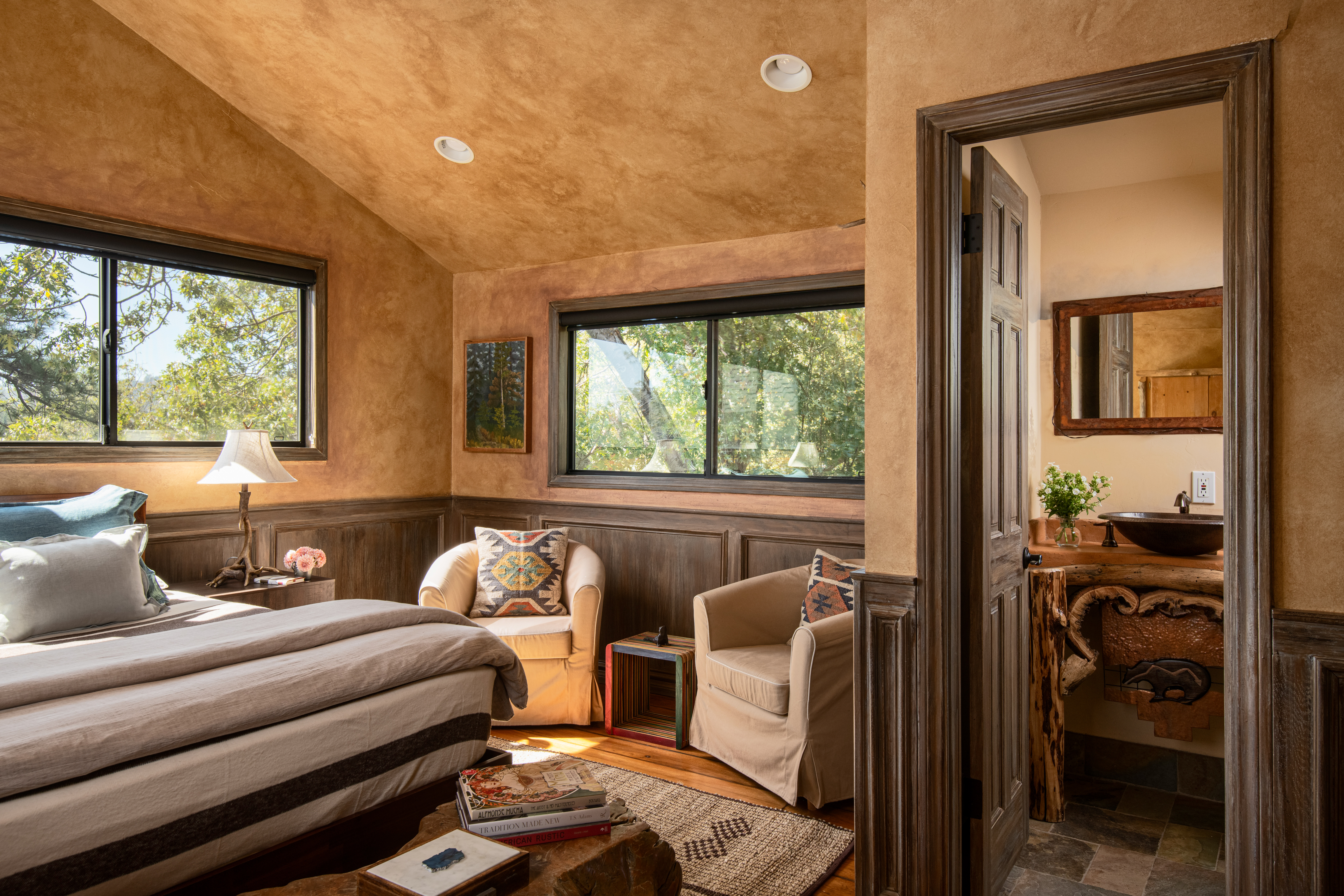 Cozy woodland bedroom with reading nook and rustic en suite bath