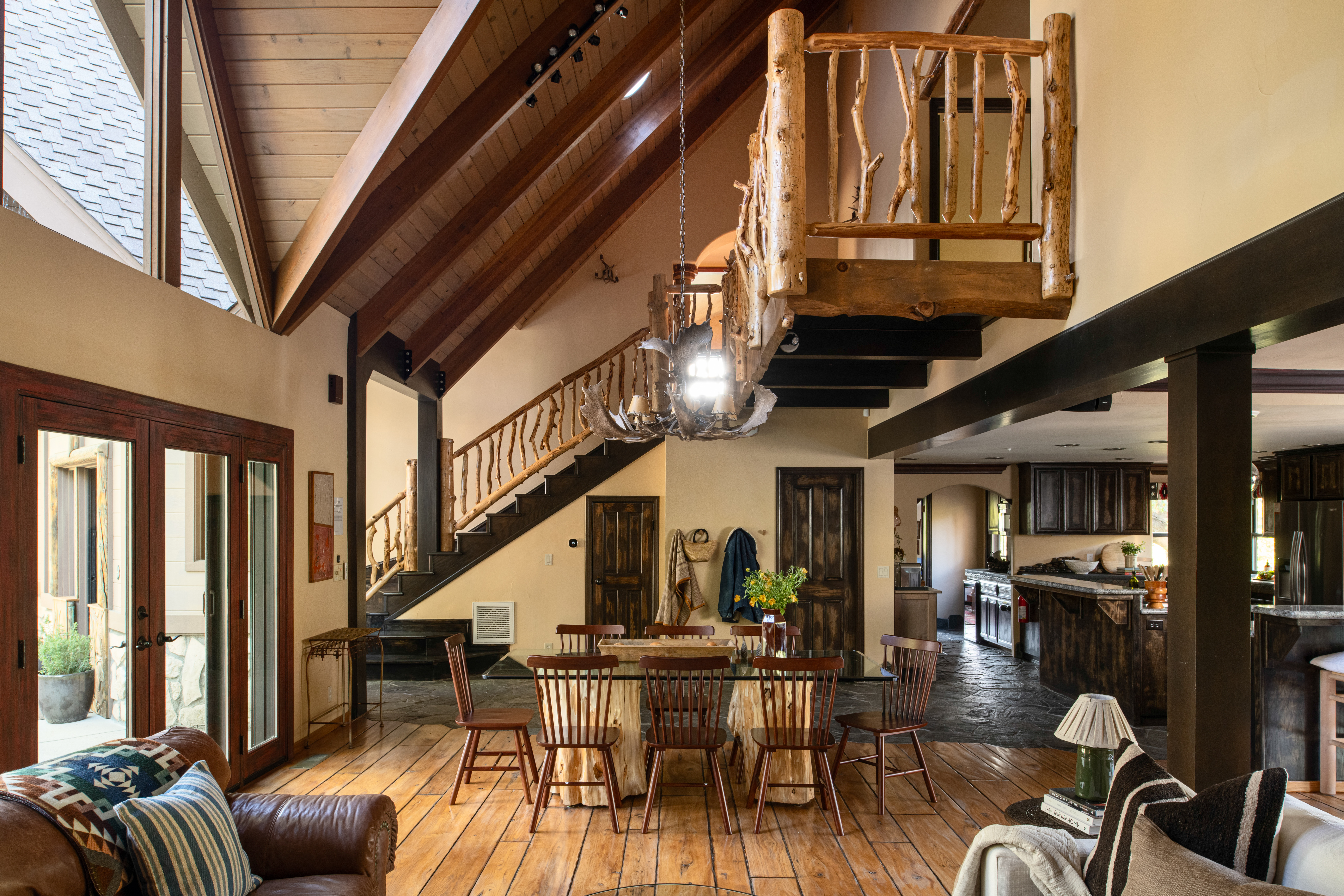 Rustic great room with vaulted ceilings, loft, and spacious dining area