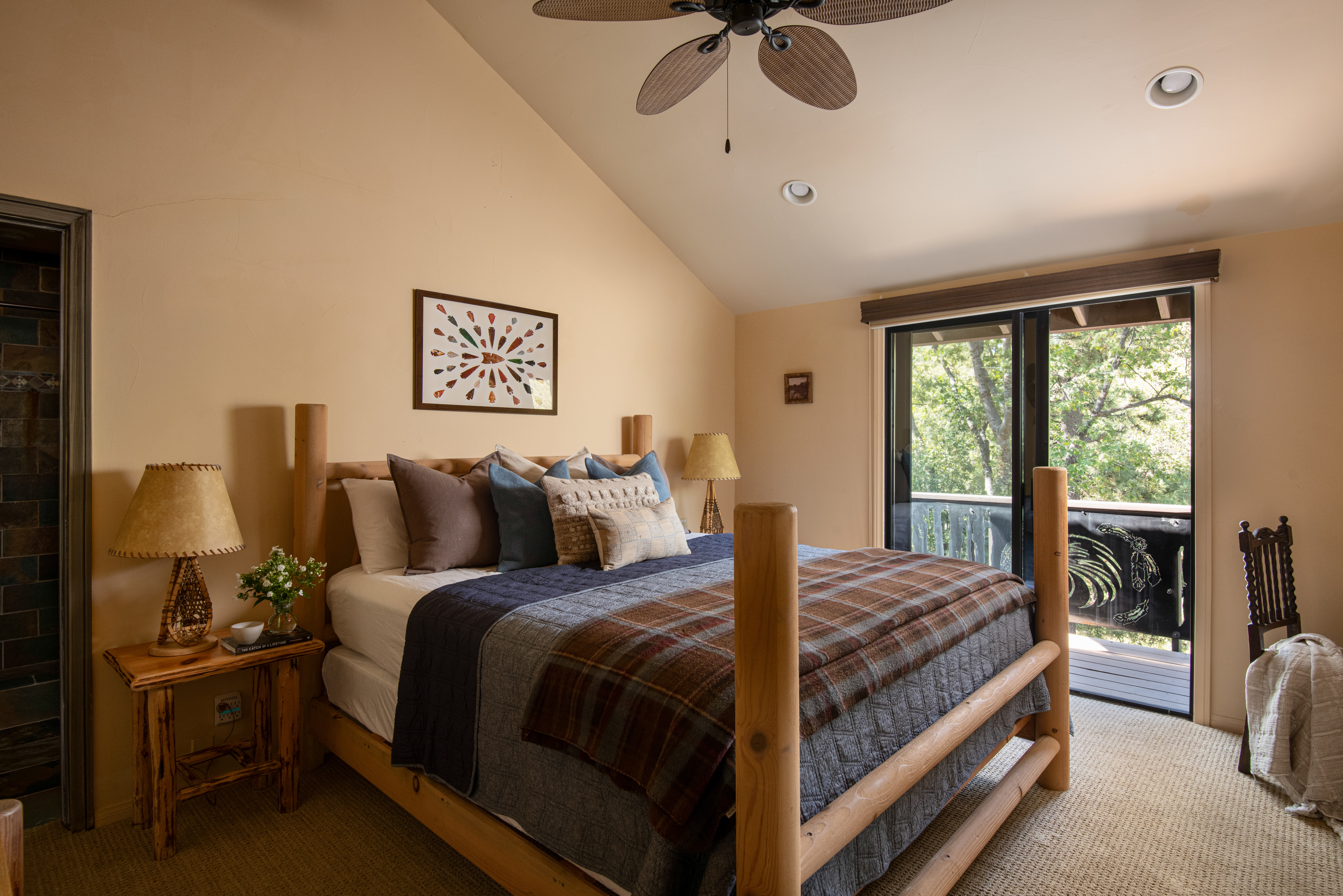 Cozy rustic bedroom with private balcony and serene treetop views