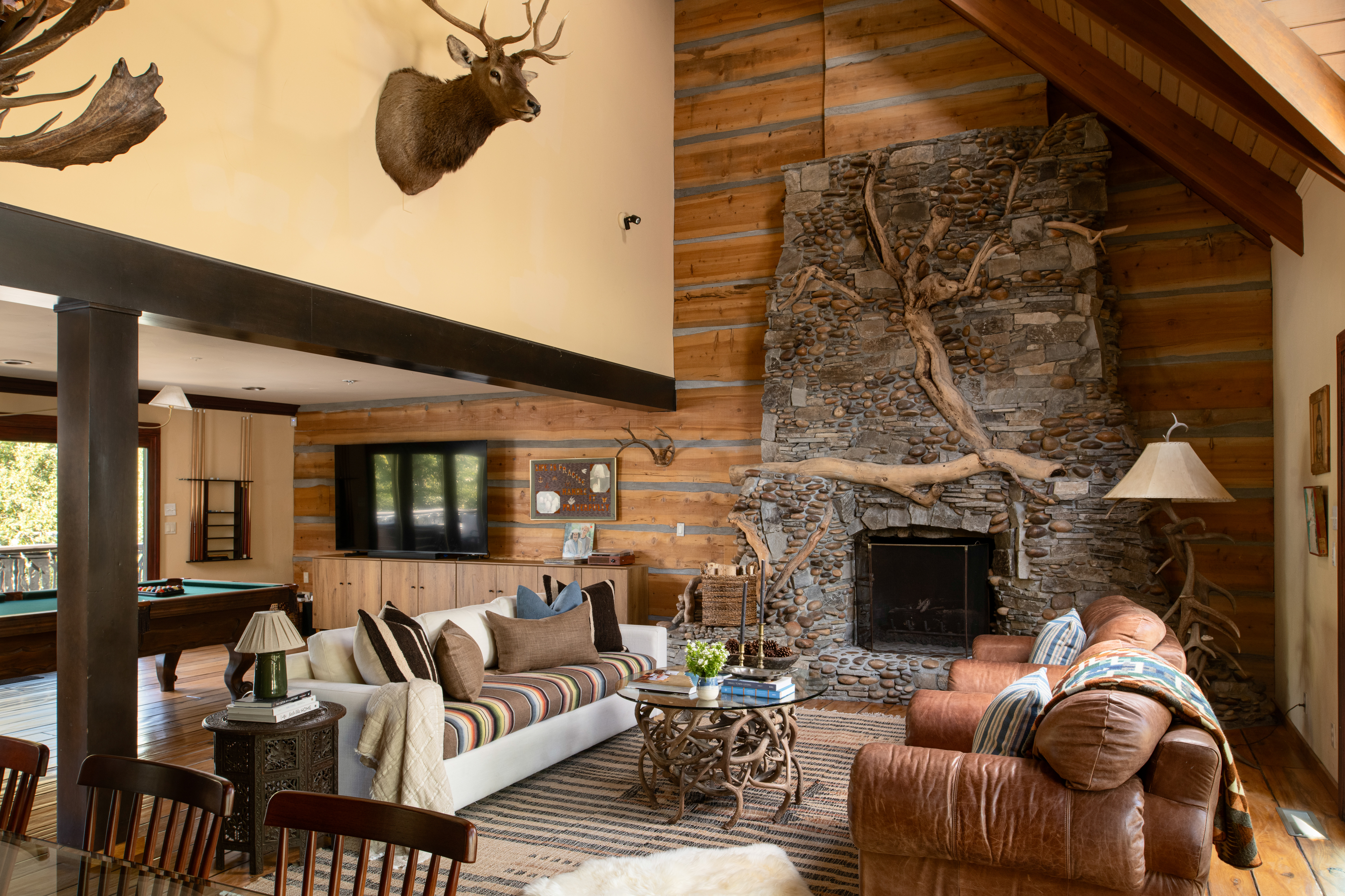 Grand rustic living room with stone fireplace and cozy lodge charm