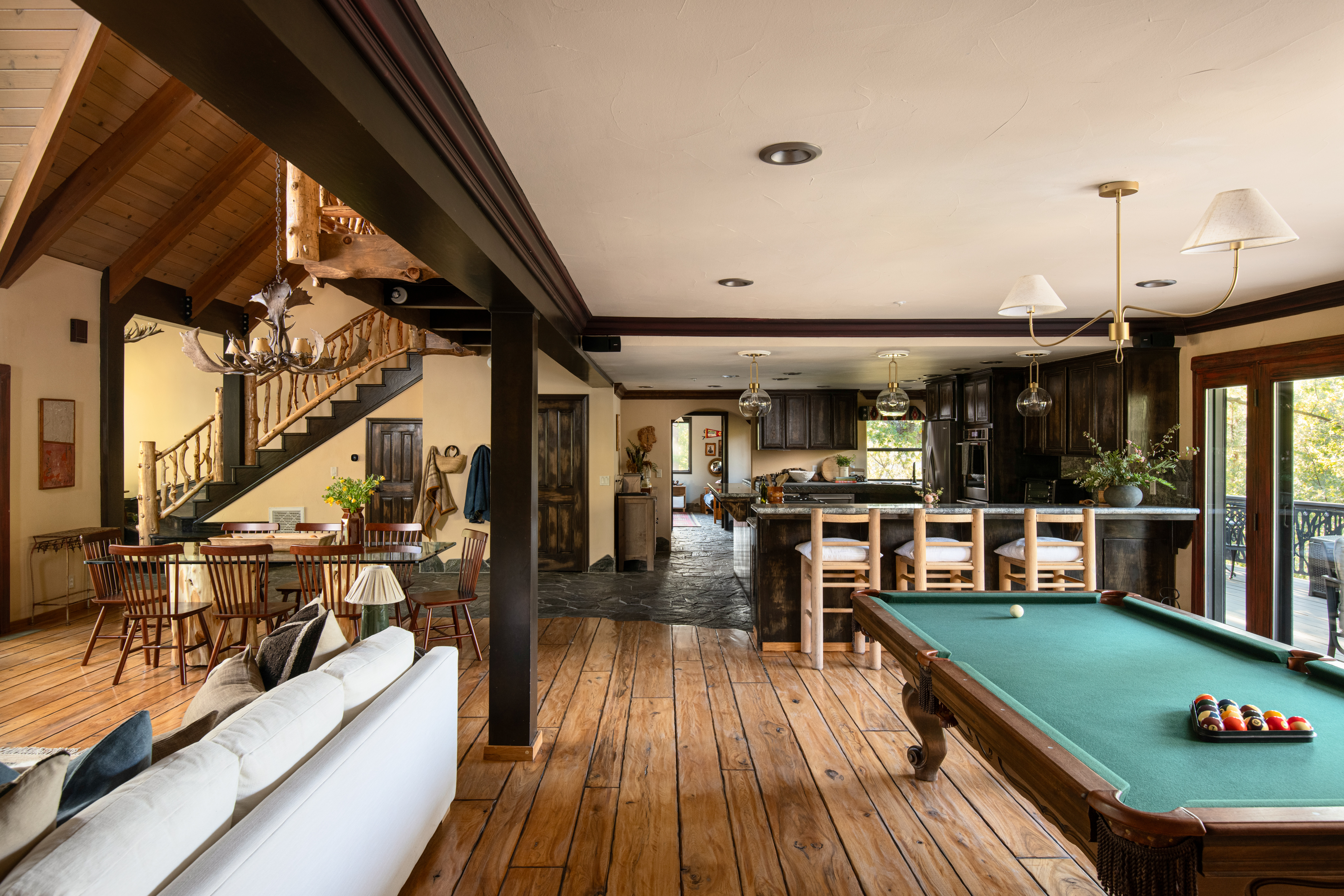 Rustic great room with pool table, bar seating, and inviting gathering spaces