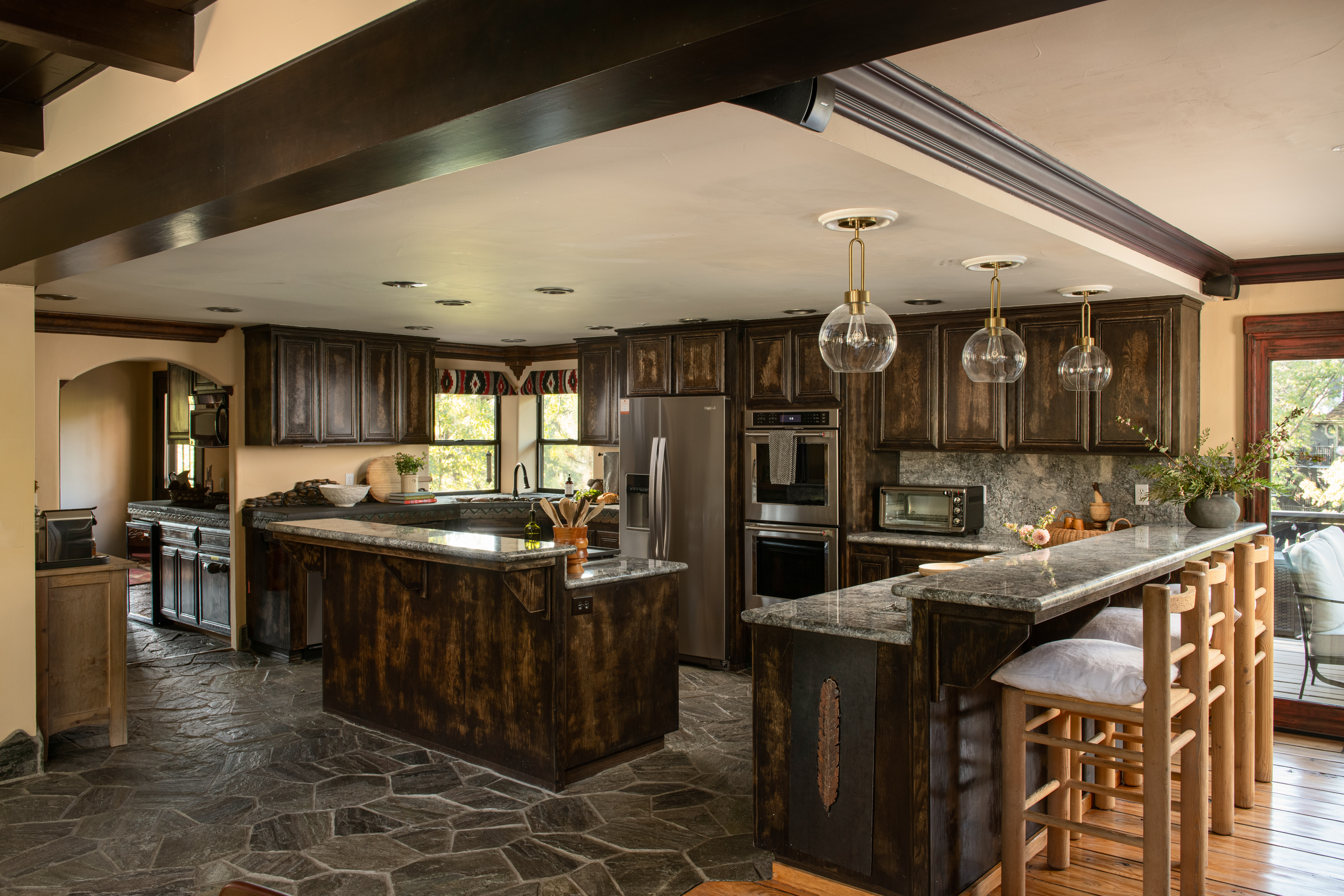 Spacious gourmet kitchen with granite islands and stylish bar seating