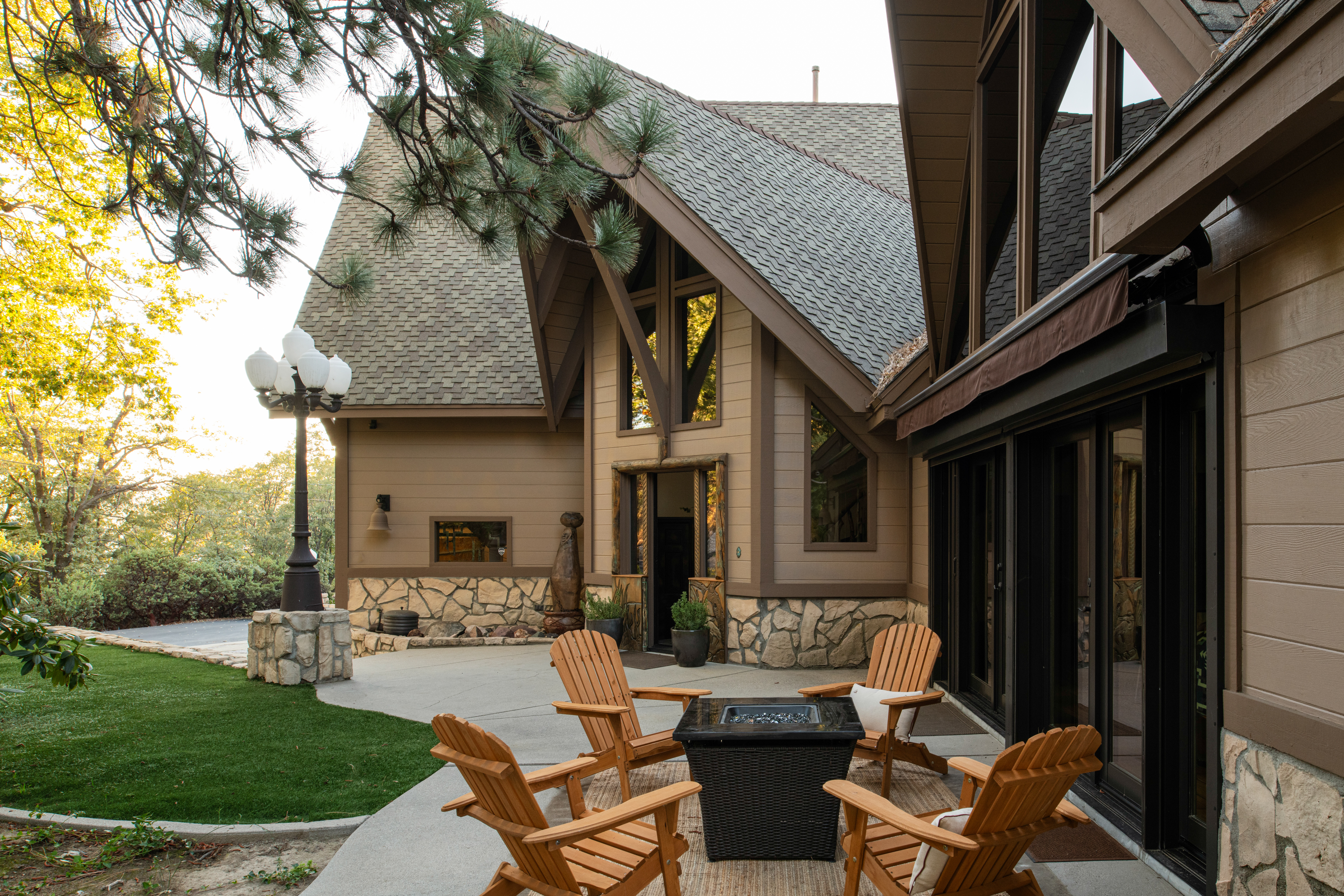 Inviting patio with fire pit, Adirondack seating, and serene wooded views