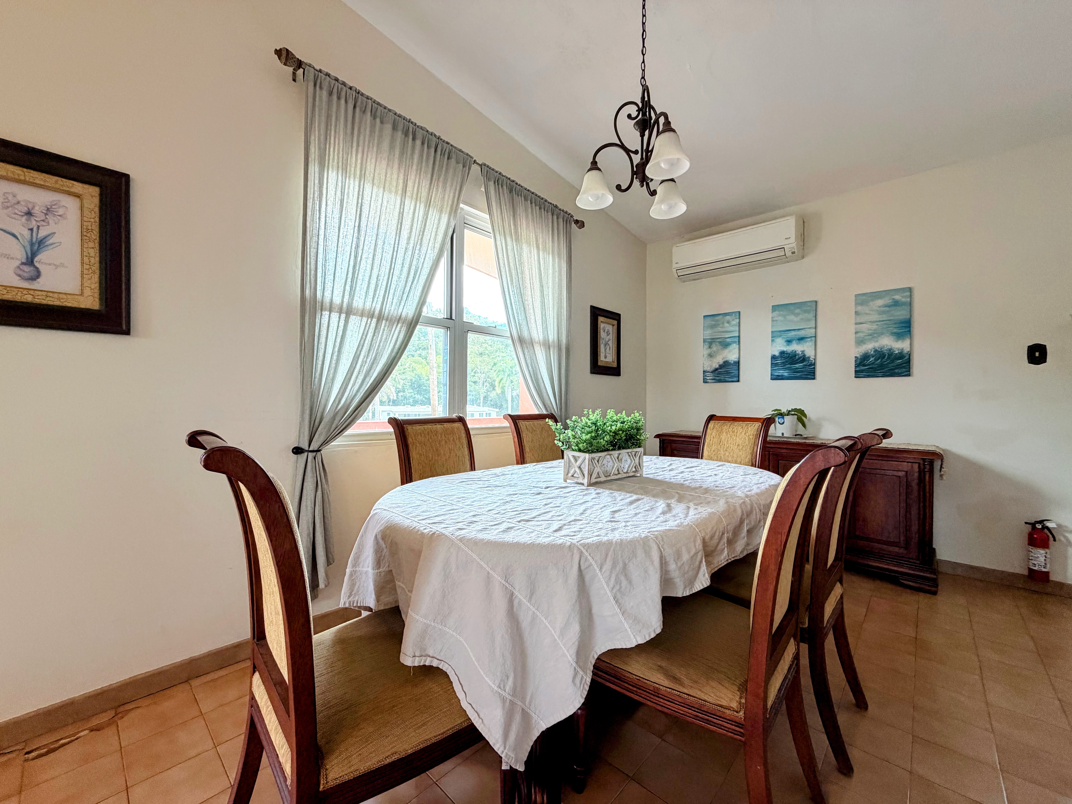 Bright dining area for 4 with natural light and A/C comfort