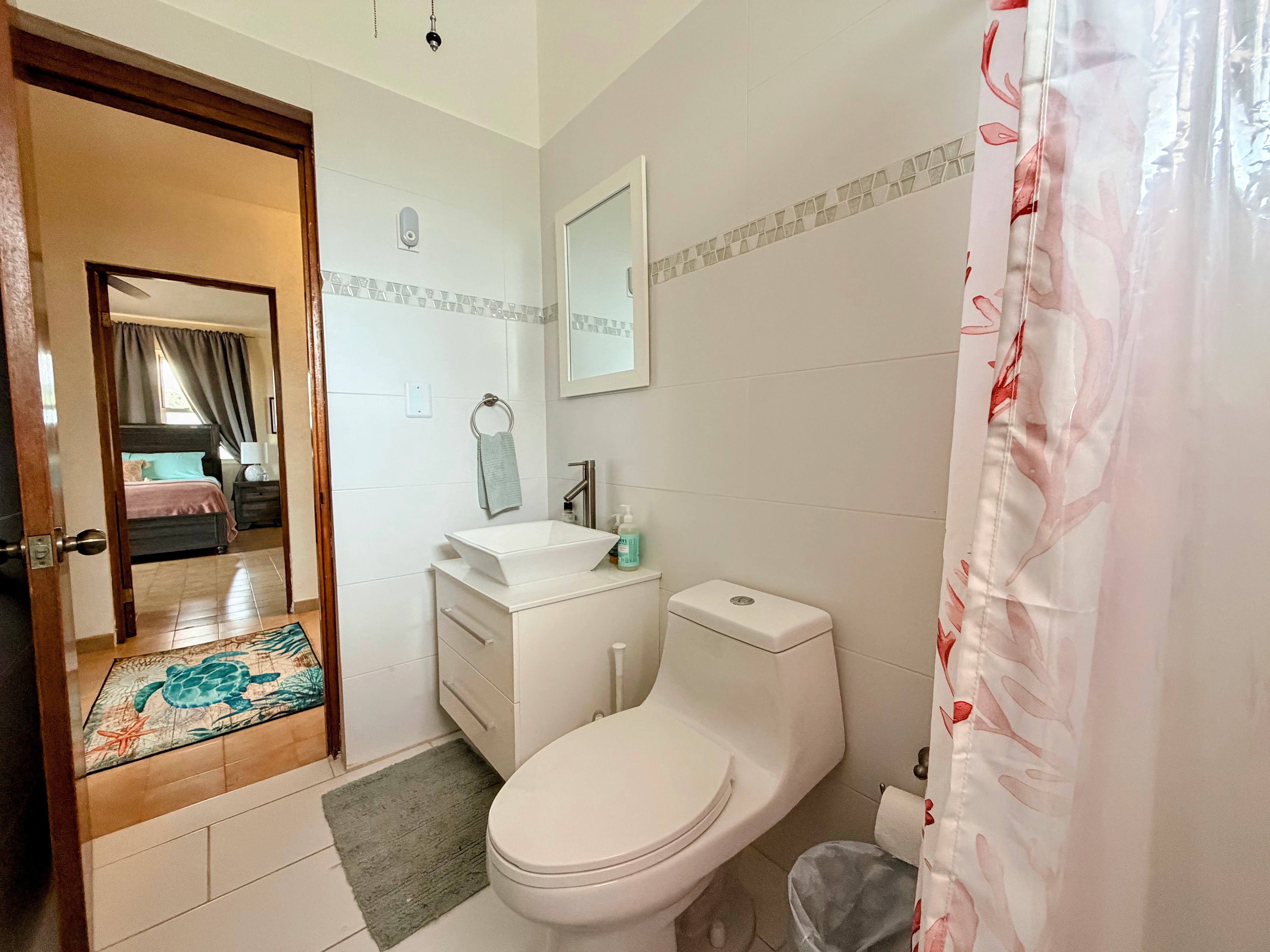 Bright modern bathroom with sleek vanity and bedroom access