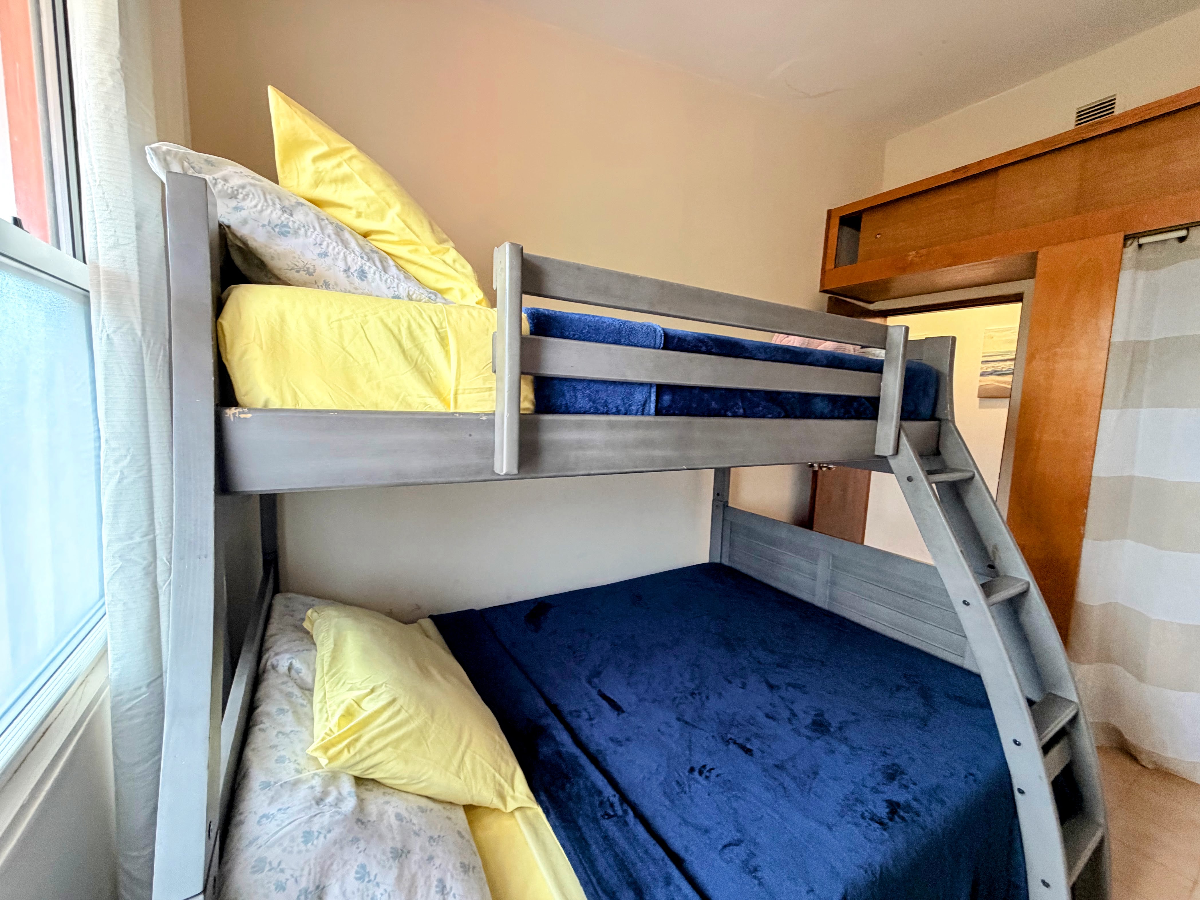 Bright bunk room with stylish sliding door—great for families or groups